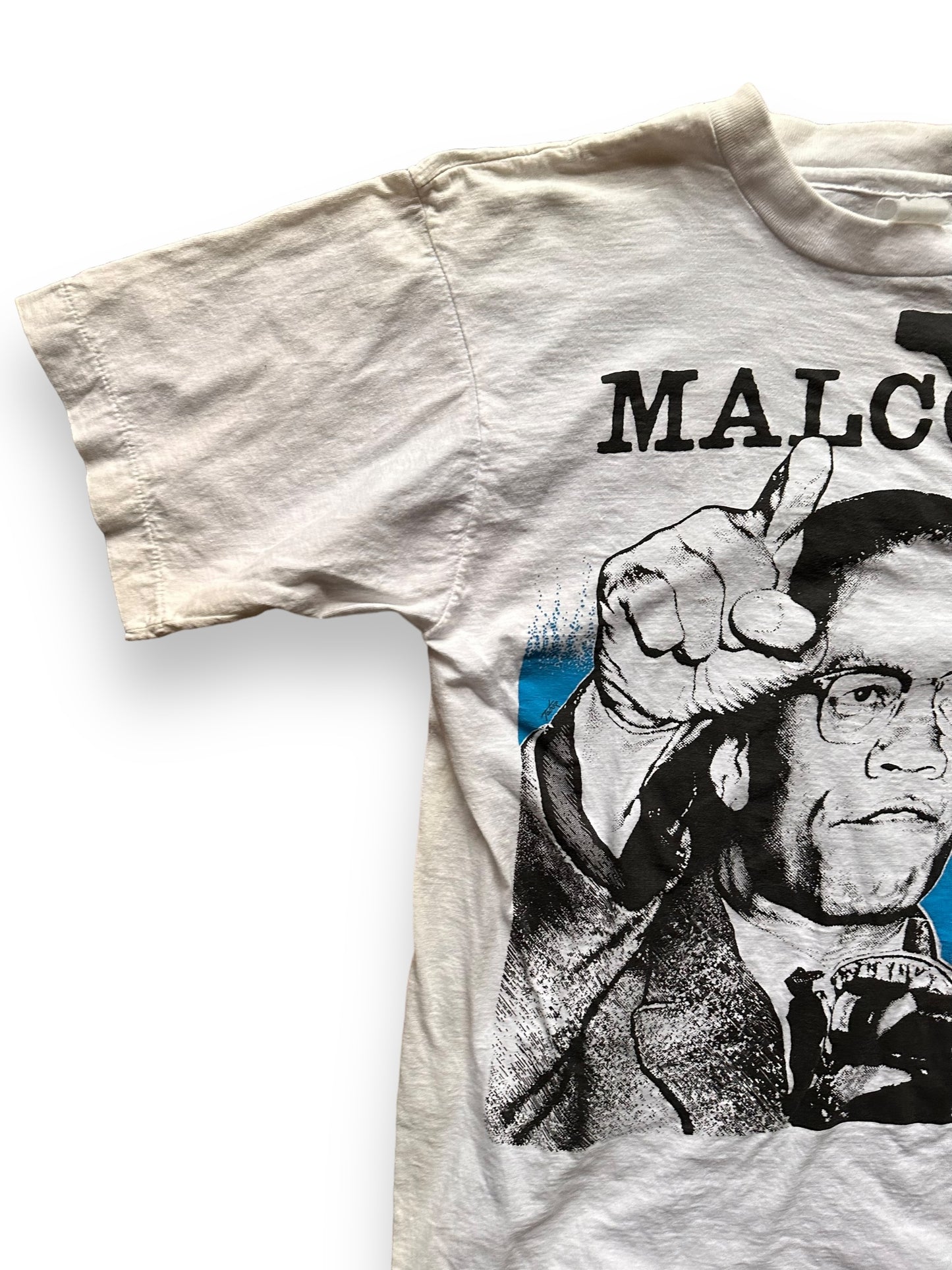 Front Left Shoulder View of Vintage 1991 Malcolm X Single Stitch Tee SZ M | Vintage Malcolm X T-Shirts Seattle | Barn Owl Vintage Clothing Seattle