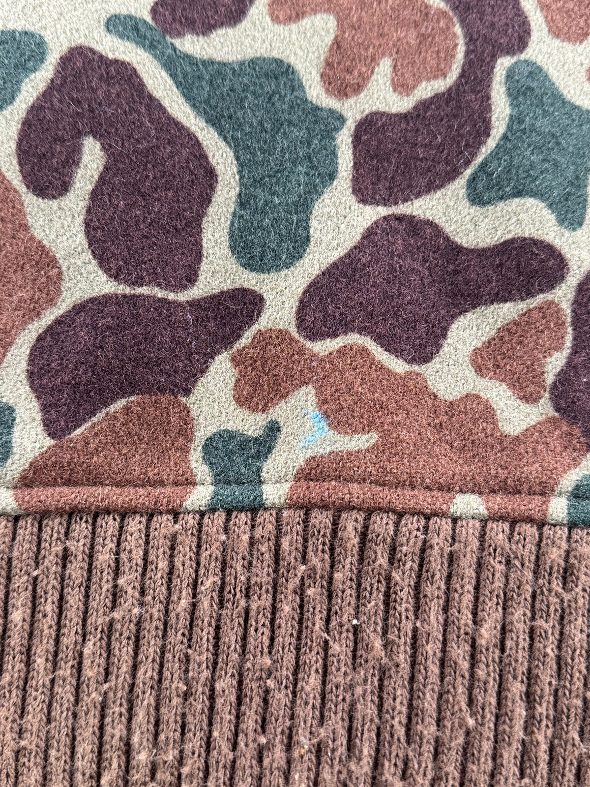 Small blur paint stain on back of Vintage Woolrich Duck Camo Bomber Jacket SZ M