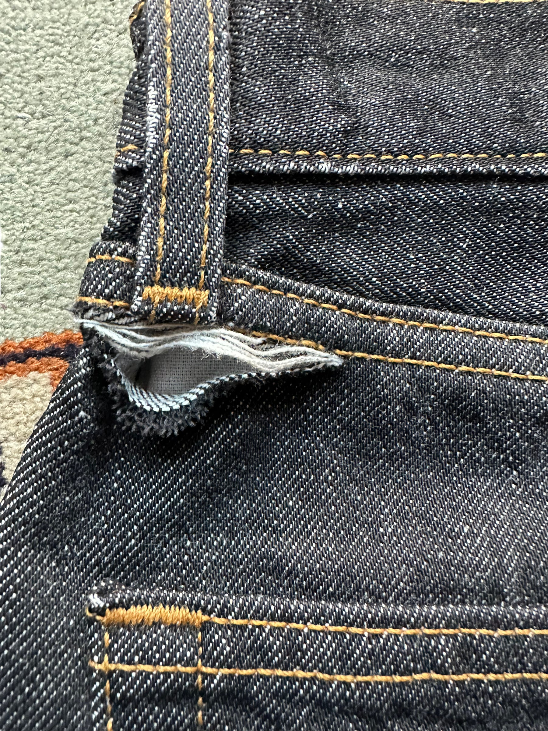 View of hole back left above pocket Deadstock 90s USA Levi's 501 Black Jeans 26x33 | Seattle Deadstock Vintage Jeans | Barn Owl Vintage Denim