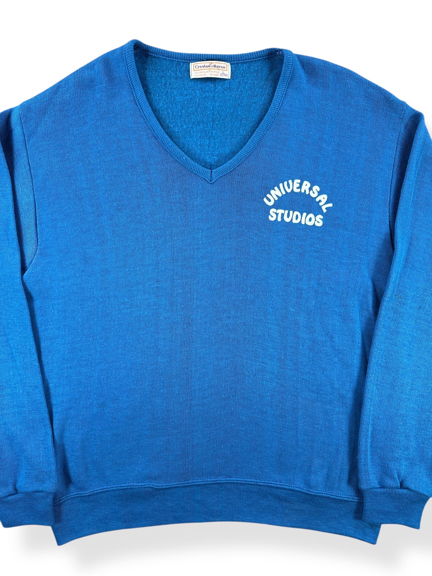 Front Close Up of Vintage Universal Studios Flocked V-Neck Sweater SZ L