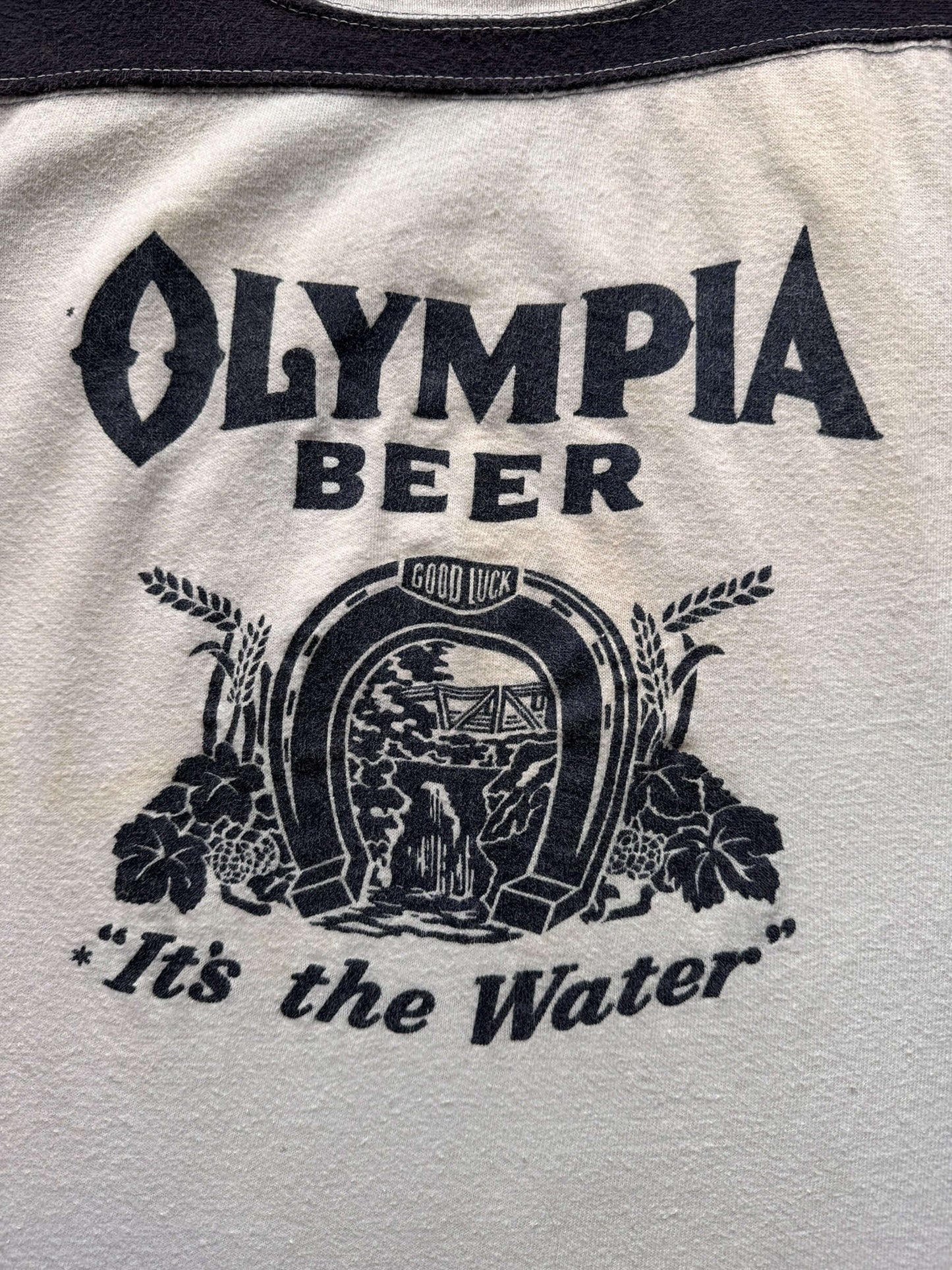 front graphic of Vintage Olympia Beer "It's The Water" Football Jersey SZ XL