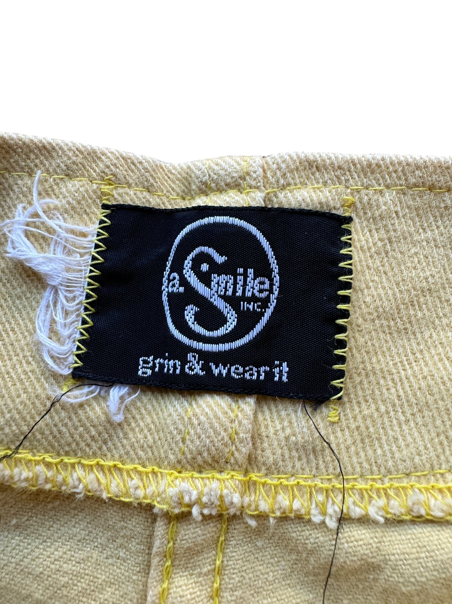 Label on Vintage Pastel Yellow Smile Co Grin & Wear It Trousers W32