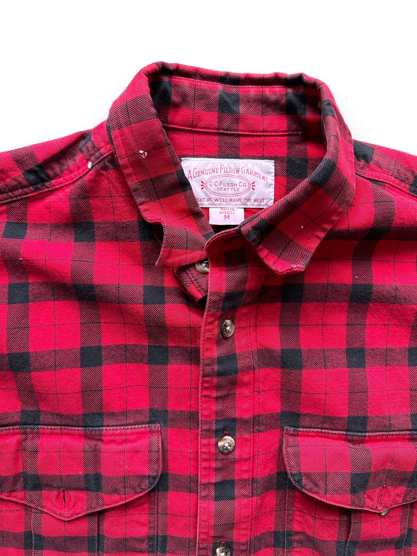 Tag View of Paint Splattered Filson Black and Red Guide Shirt SZ M | Barn Owl Vintage Goods | Vintage Filson Workwear Seattle