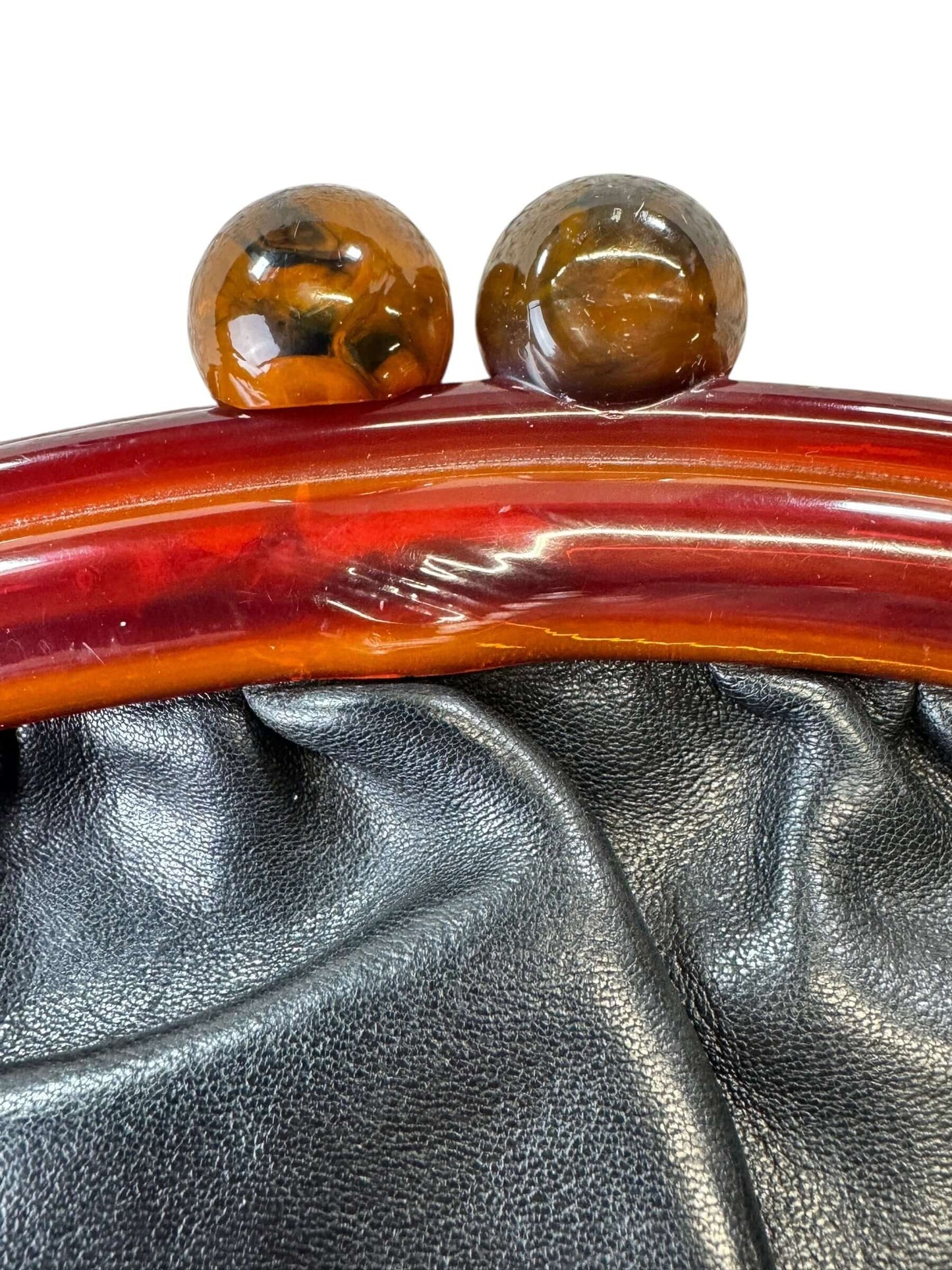 Flaw on handle of 1950s Black Leather Clutch with Lucite Handle