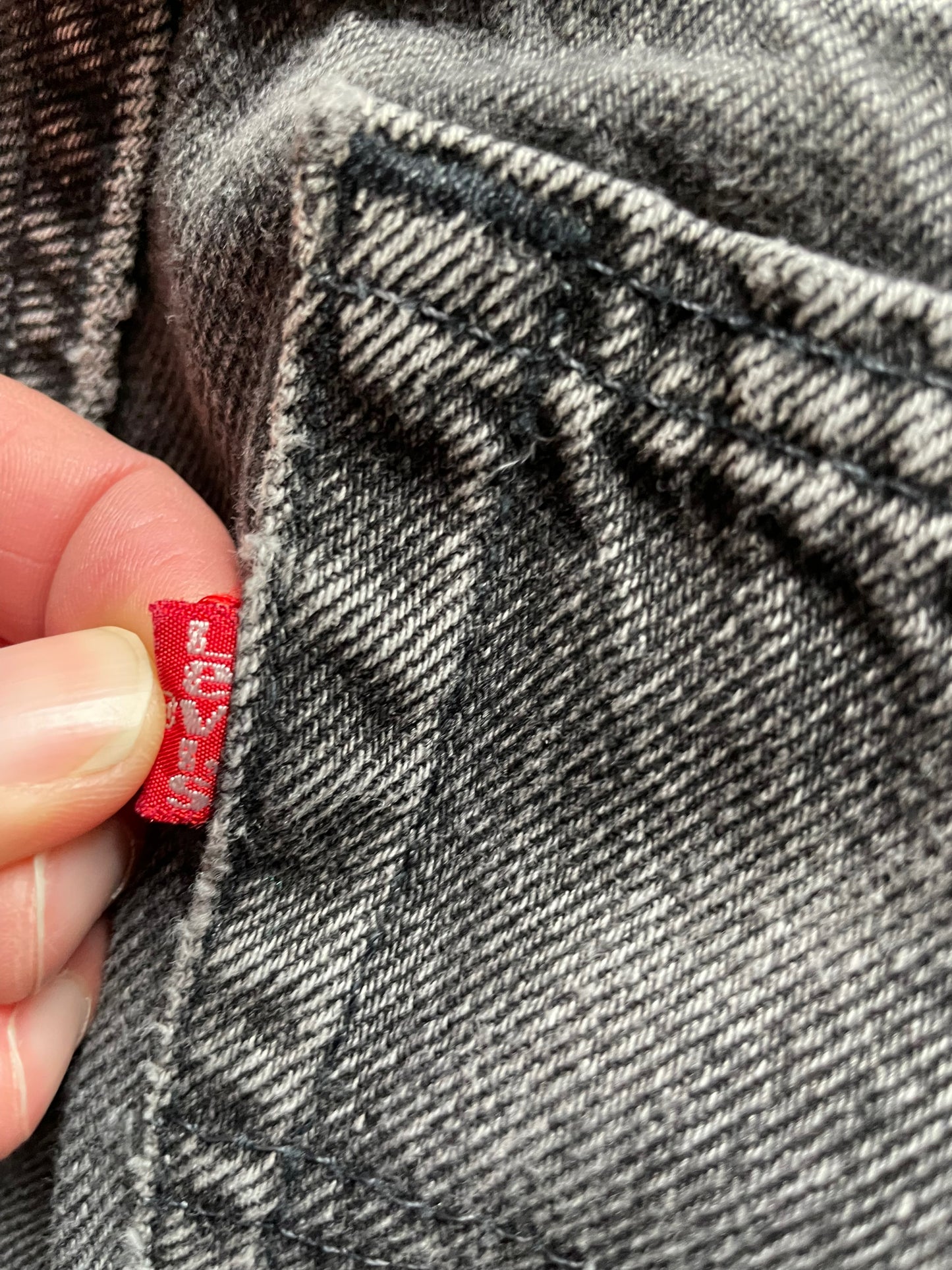 Red tag view of Vintage USA Mended Black Levi's 550s 33x34