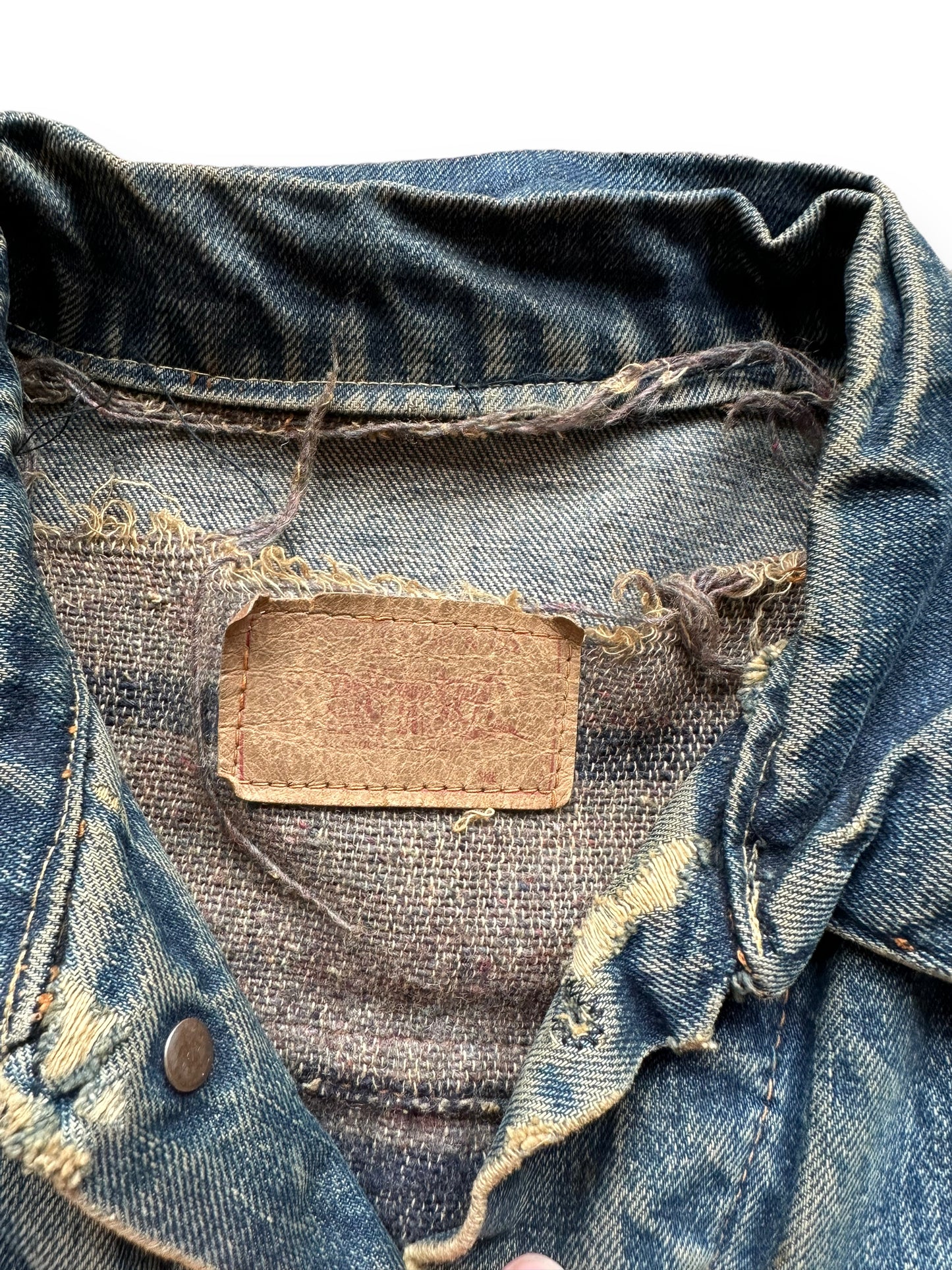 Damage close up + tag detail shot of Levi's Big E Type III Blanket Lined Trucker w/ Butterfly Embroidery SZ 42 | Vintage Denim Workwear Seattle | Seattle Vintage Denim