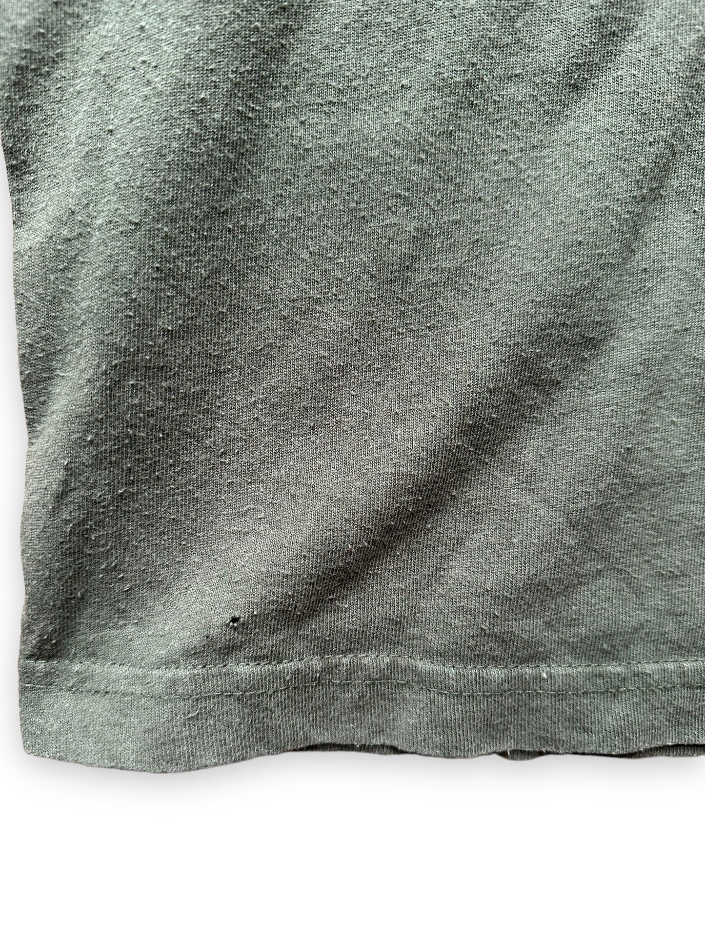 Small Hole by Hem on Olive Green Filson Cotton Tee SZ XS | Barn Owl Vintage Goods | Filson Graphic Tees Seattle