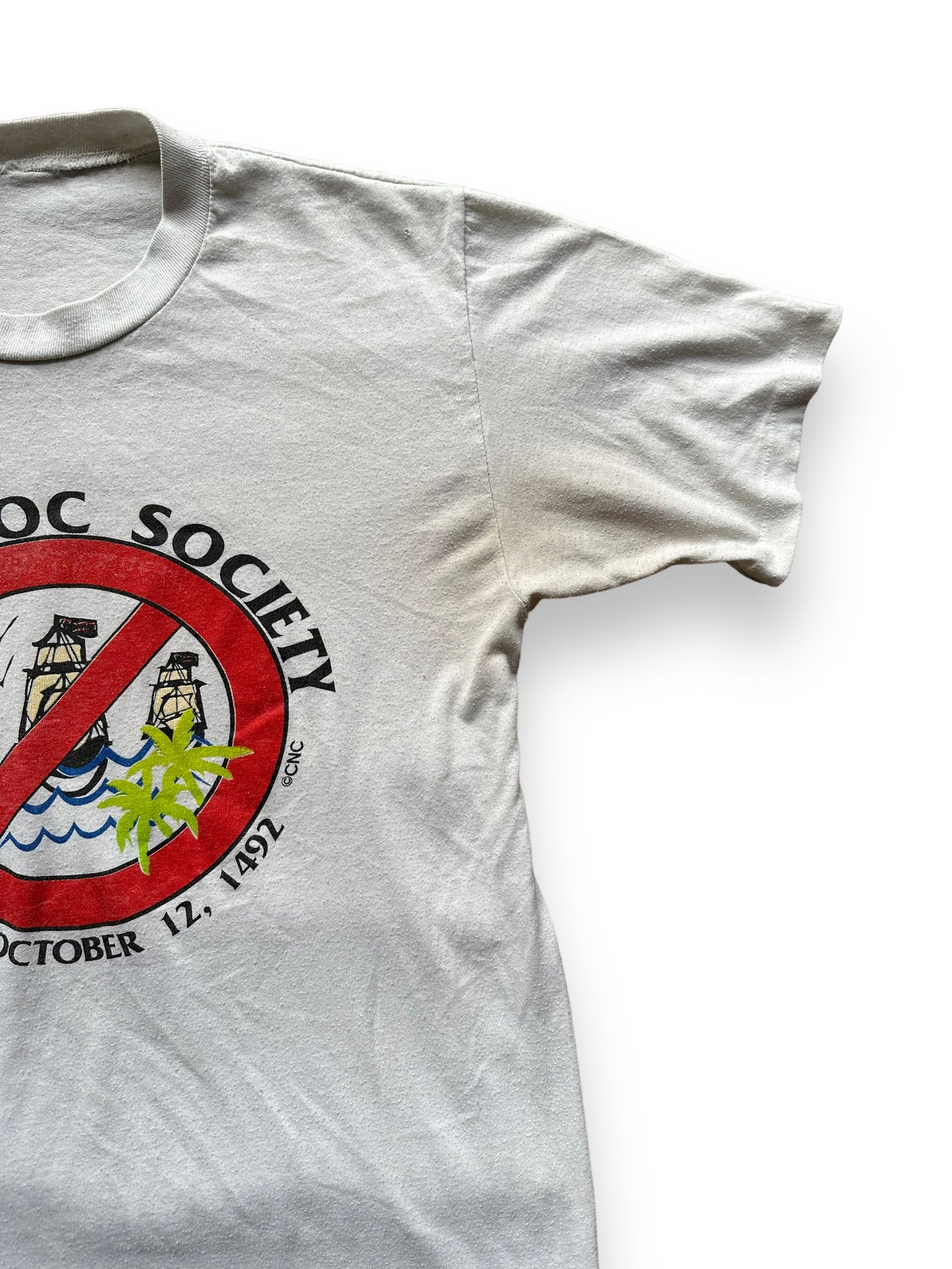 Slight Pitting on Left Pit of Vintage Submuloc First Nations Anti-Columbus Tee SZ M | Vintage Graphic T-Shirts Seattle | Barn Owl Vintage Tees Seattle