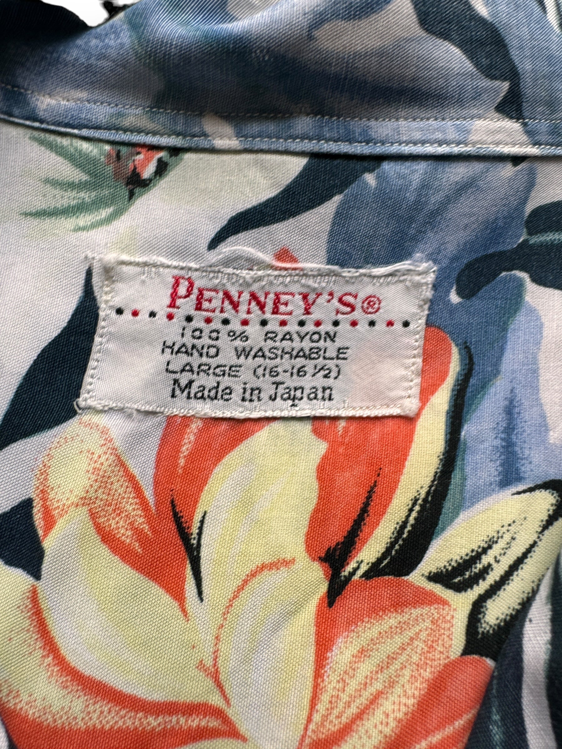 tag on Vintage Made in Japan Navy Blue/Orange Floral Penney's Aloha Shirt SZ L