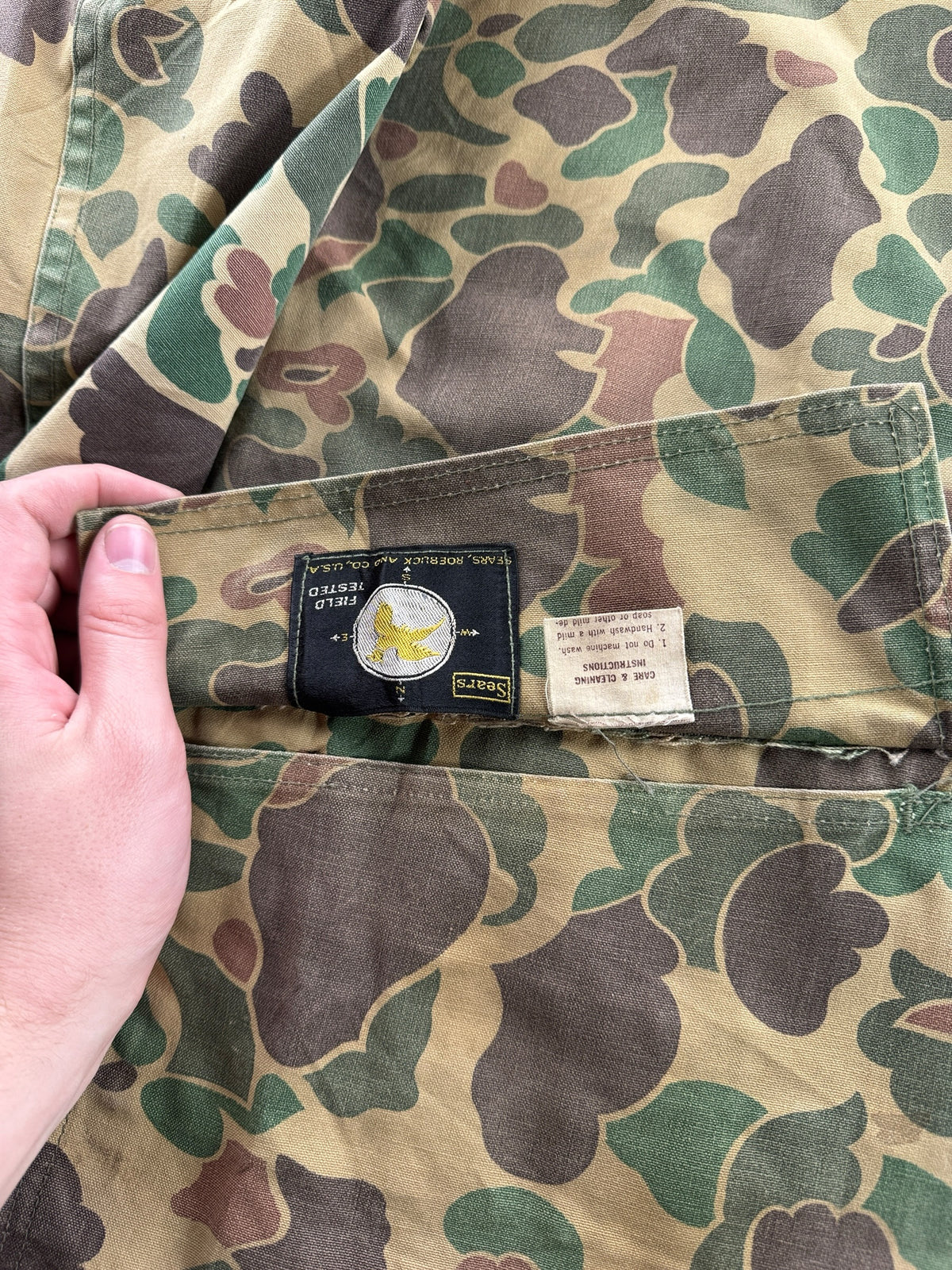 Tags inside pocket on Vintage Duck Camo Reversible Hunting Jacket SZ L