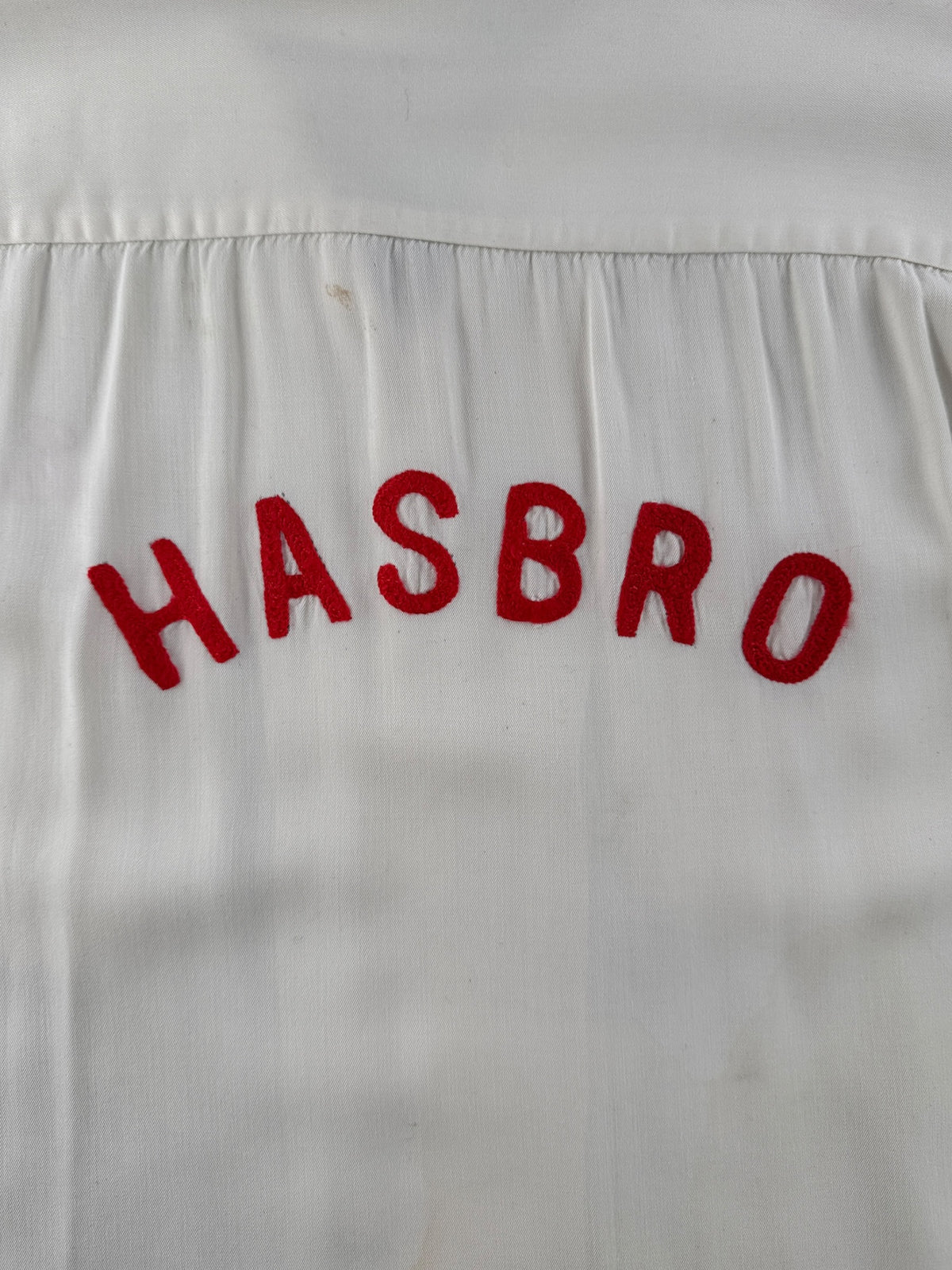 Chainstitched Hasbro logo on back of Vintage Hasbro Chain Stitched Rayon Bowling Shirt SZ L