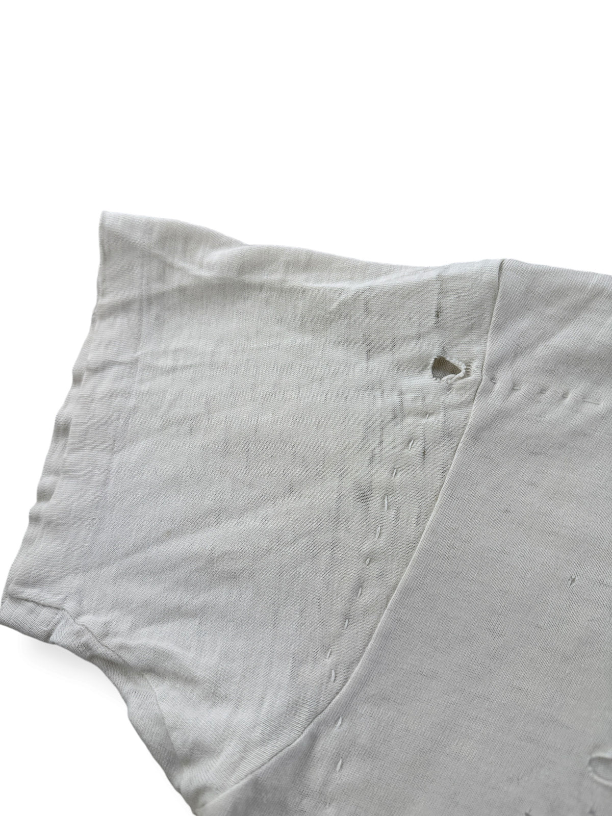 Hole on sleeve of Vintage Heavily Repaired Blank White Tee SZ M