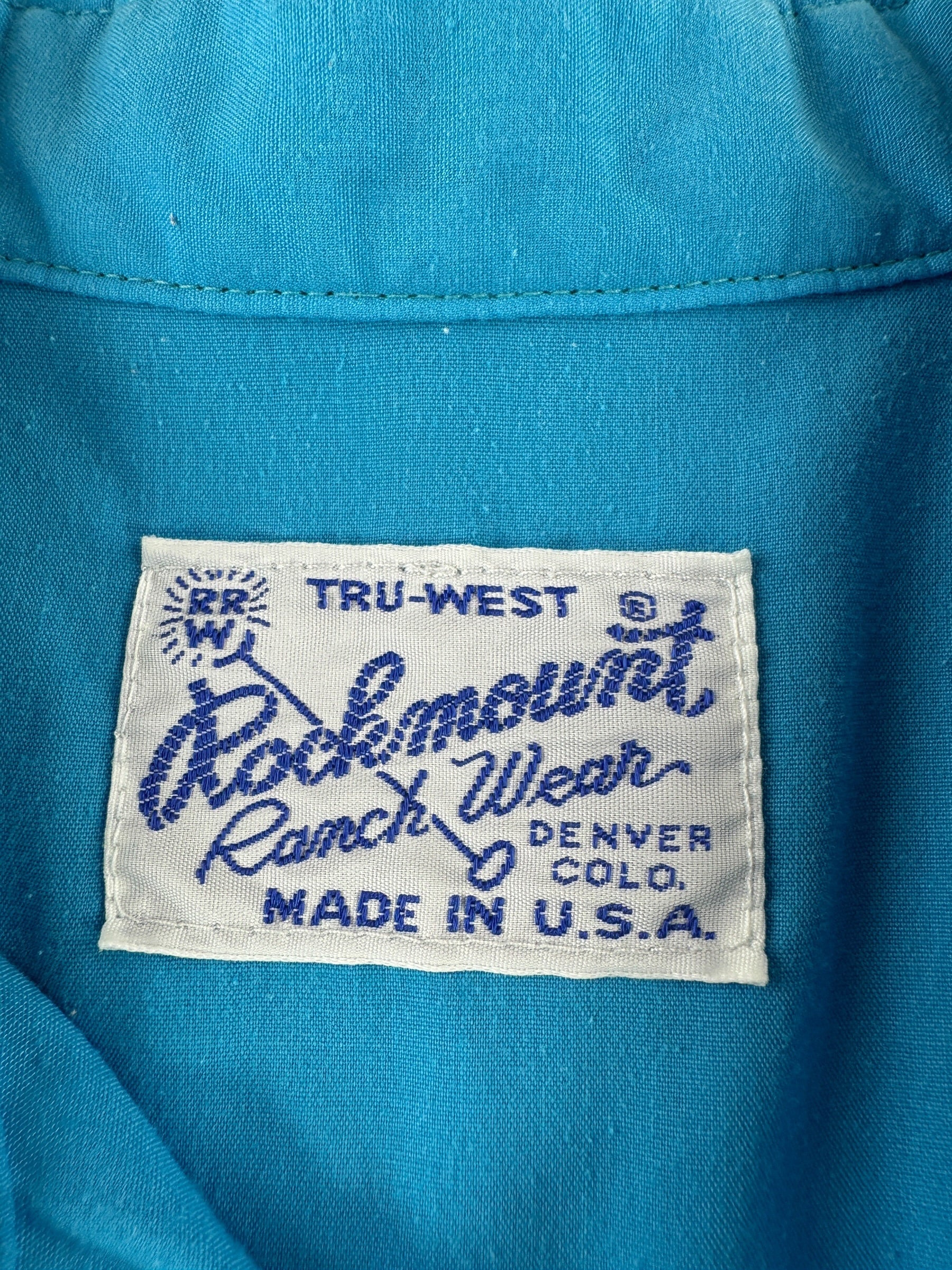 Label on Vintage Rockmount Electric Blue Pearl Snap SZ L