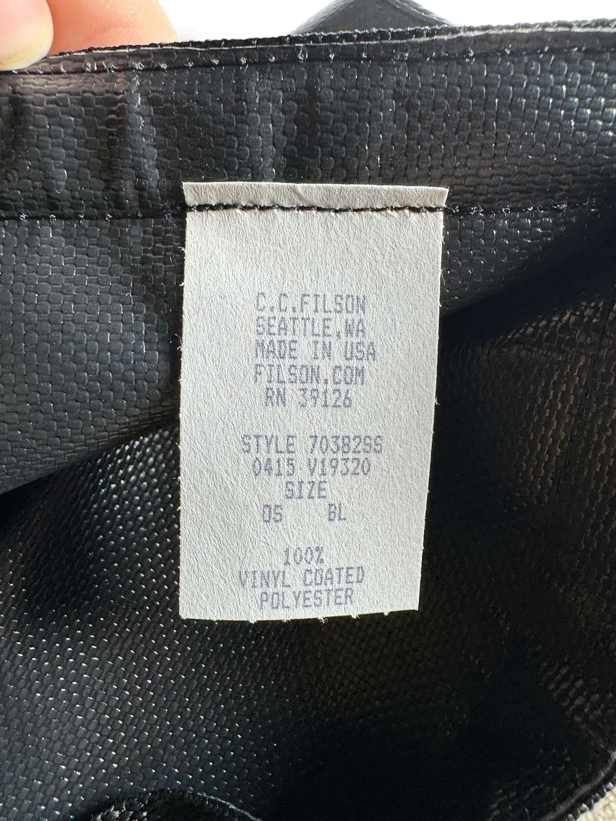 Care tag and bodle tag on inside of Filson Dry Duffel Small Design Production Sample
