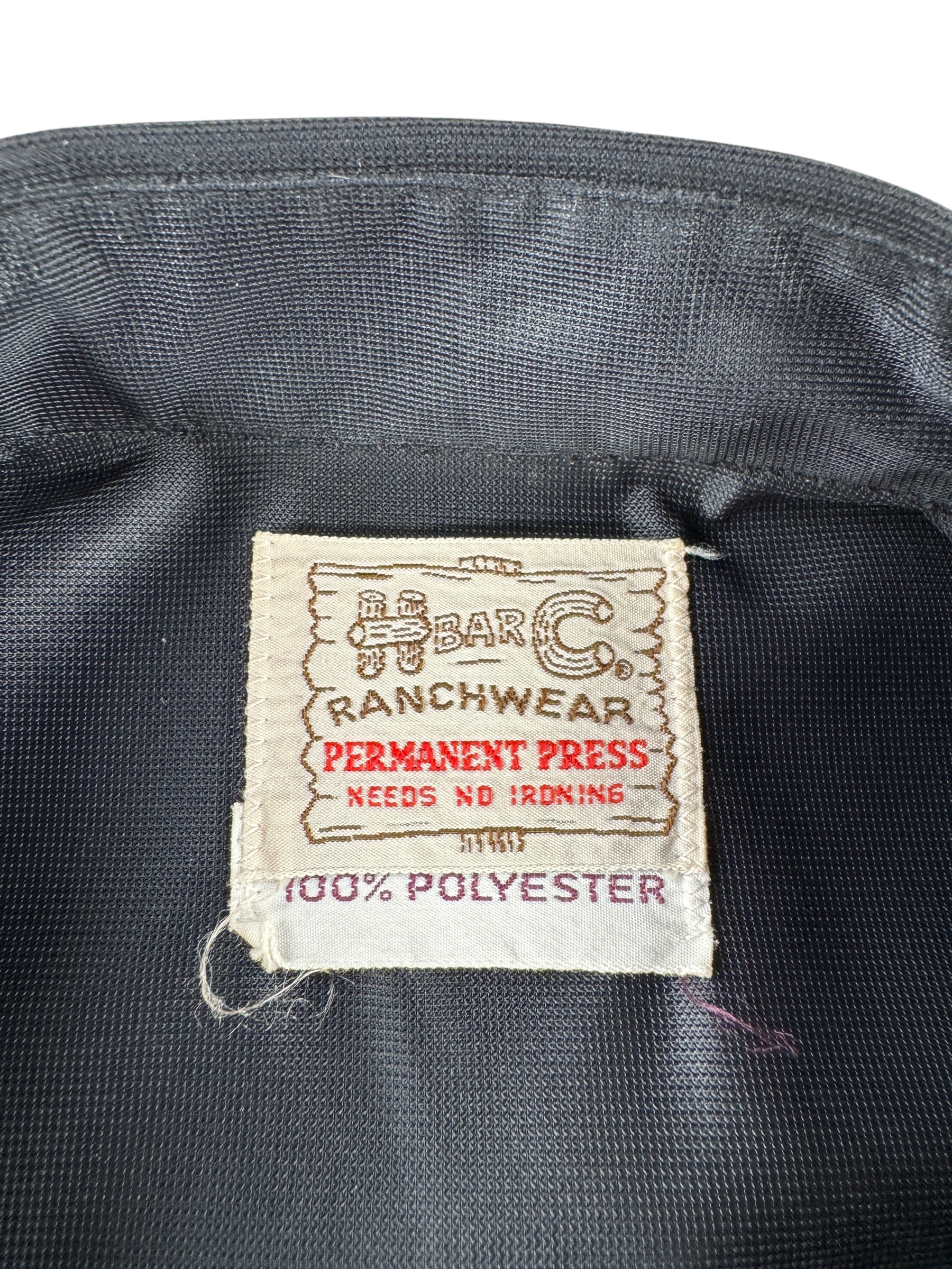 Label on Vintage H Bar C Black Polyester Flowers & Horseshoe Pearl Snap SZ L