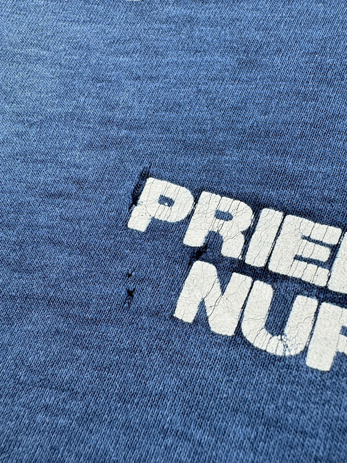 Holes around front graphic on Vintage Faded Prien Pines Nursery Tee SZ L