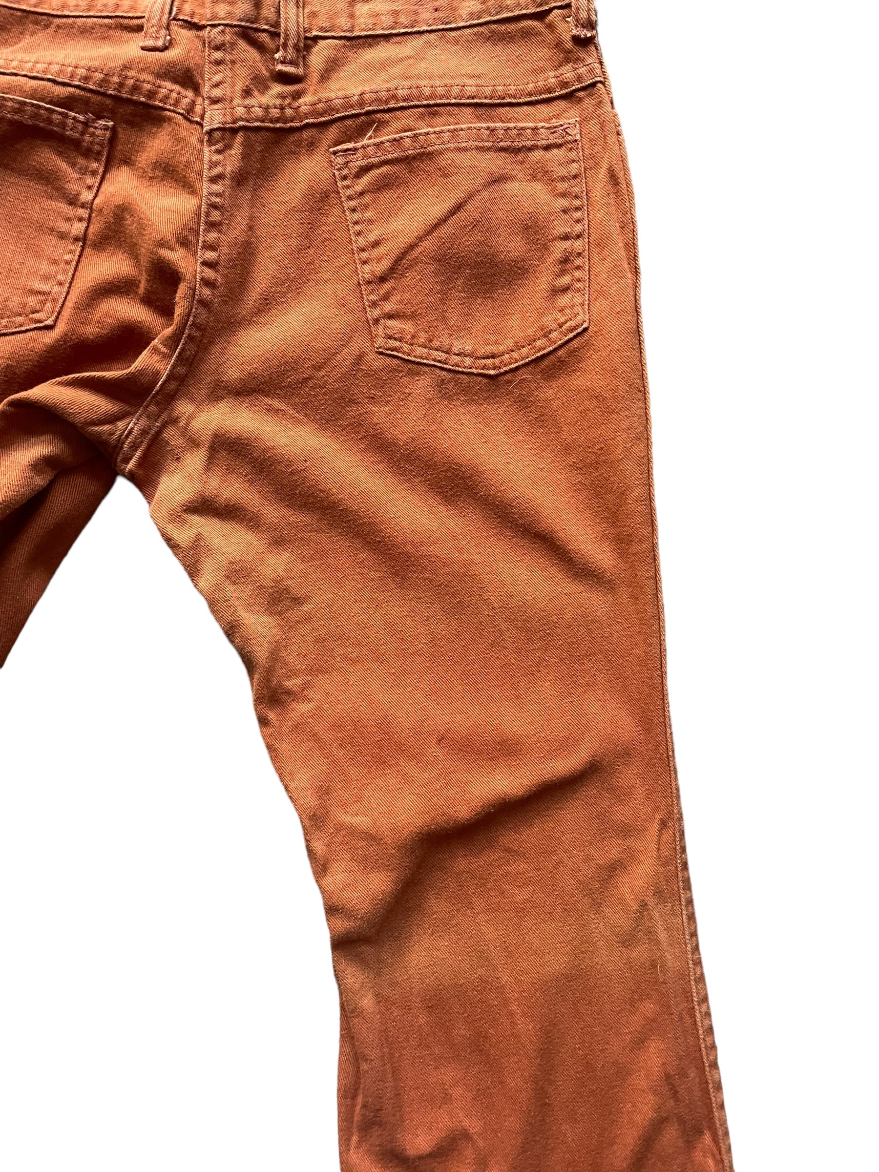 Back right leg fading view of Vintage 1970s Rusty Orange Bells W30 | Barn Owl Vintage Seattle | Vintage Pants and Denim