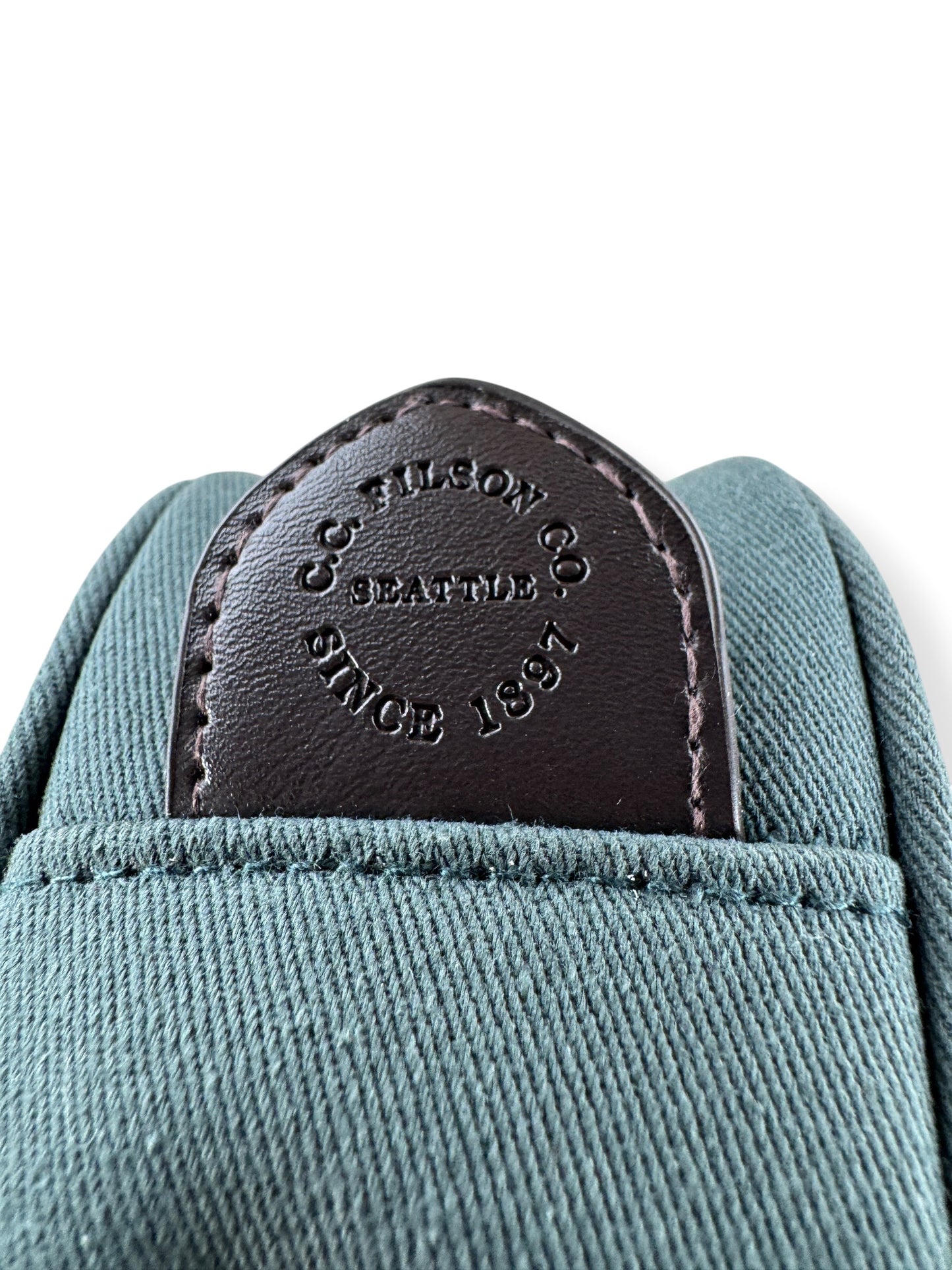 Filson pull tab on Filson X Alaska Airlines Mini Accessories Bag