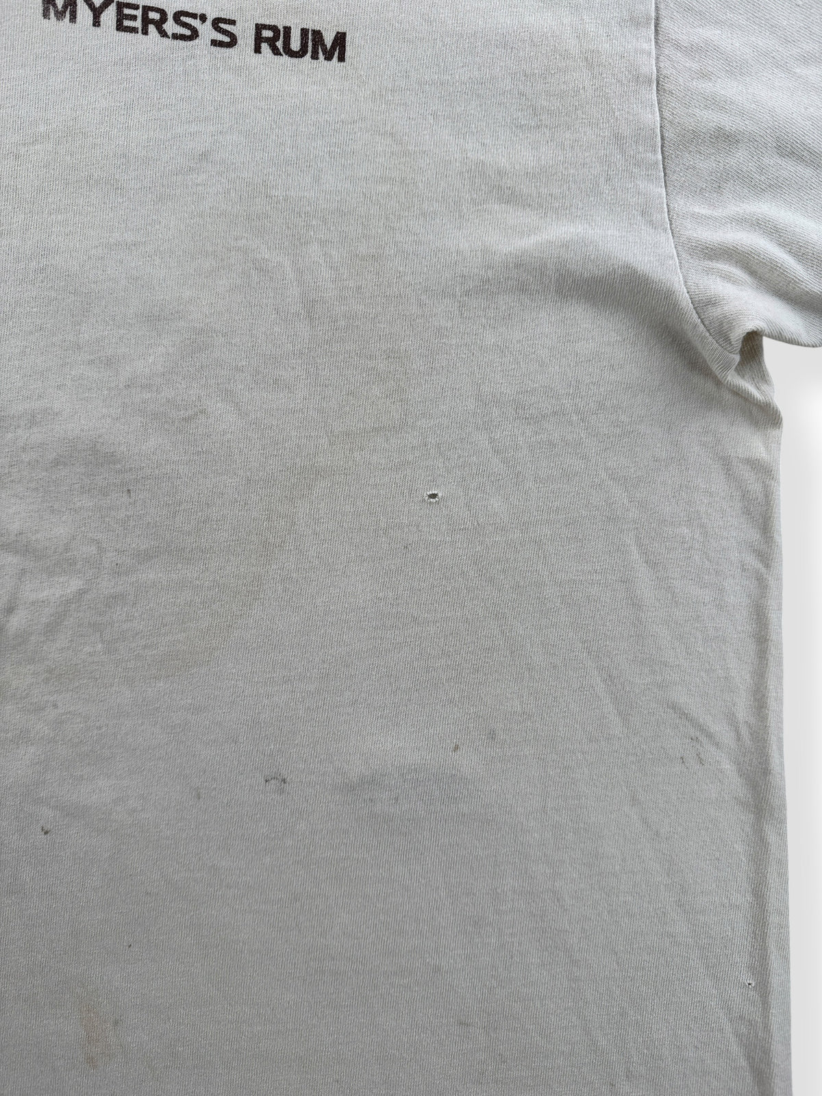 Small holes on front of Vintage Distressed Myer's Rum Tee SZ L