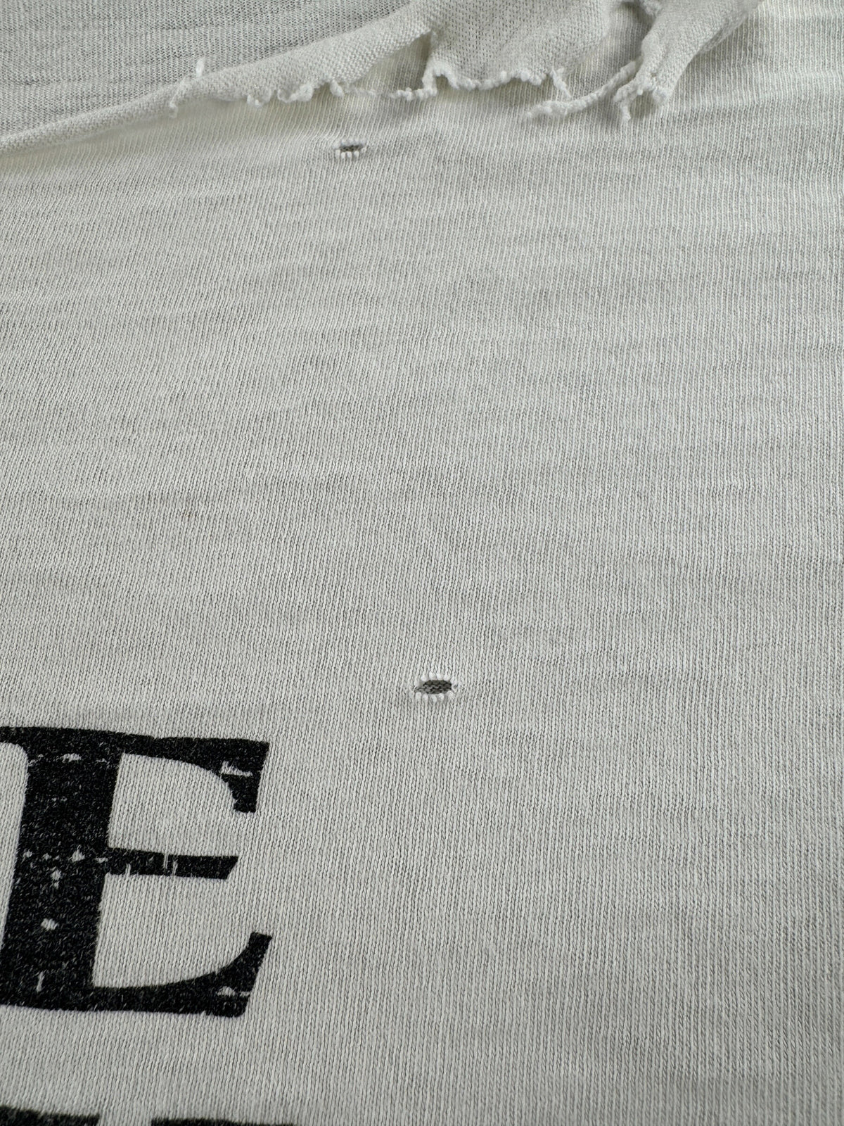 Small hole on front of Vintage Thrashed Give Racism The Boot Timberland Tee SZ XL