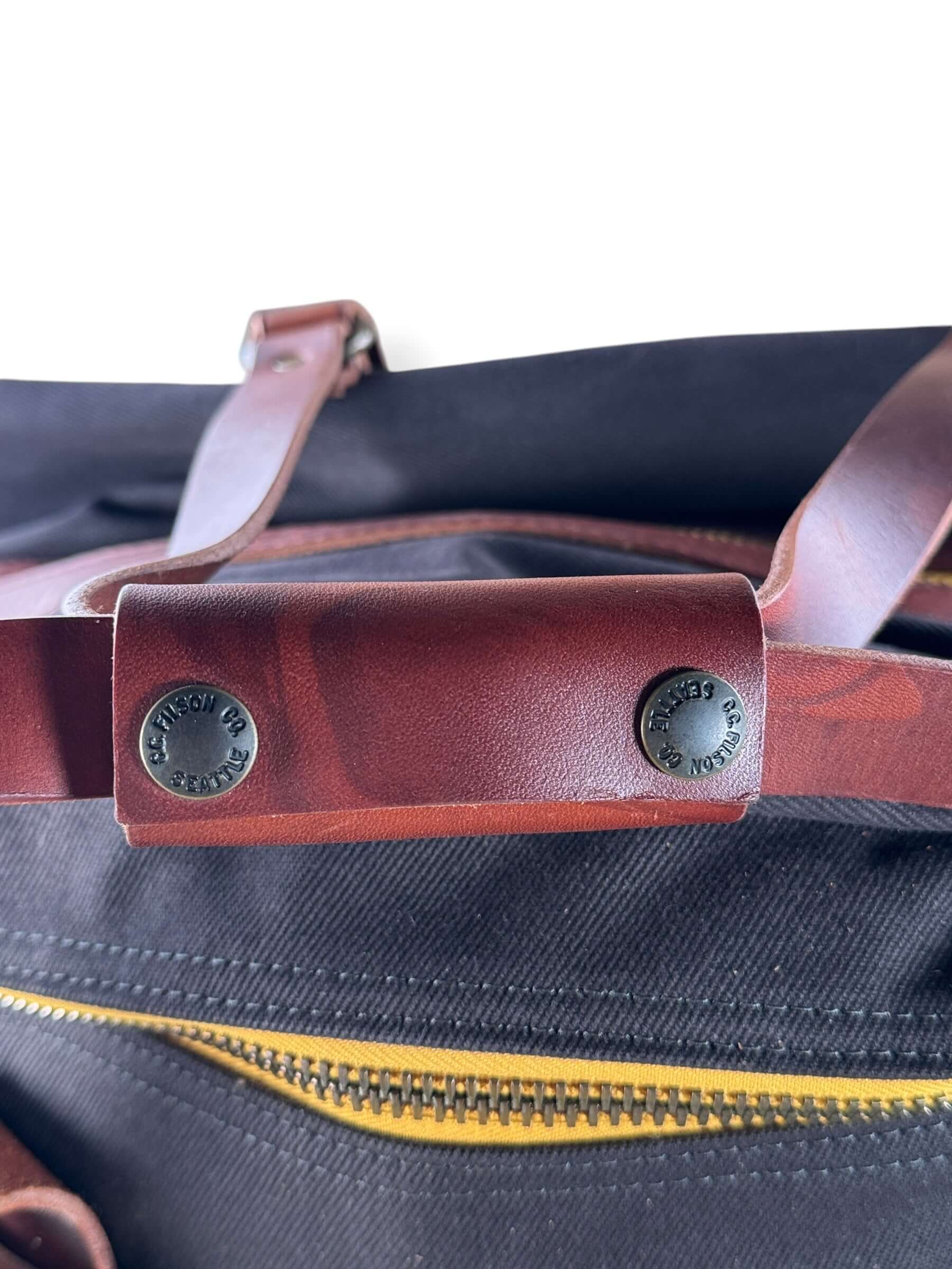 Filson leather strap on Filson x Chris Stapleton Traveller Outfitter Bag NWOT