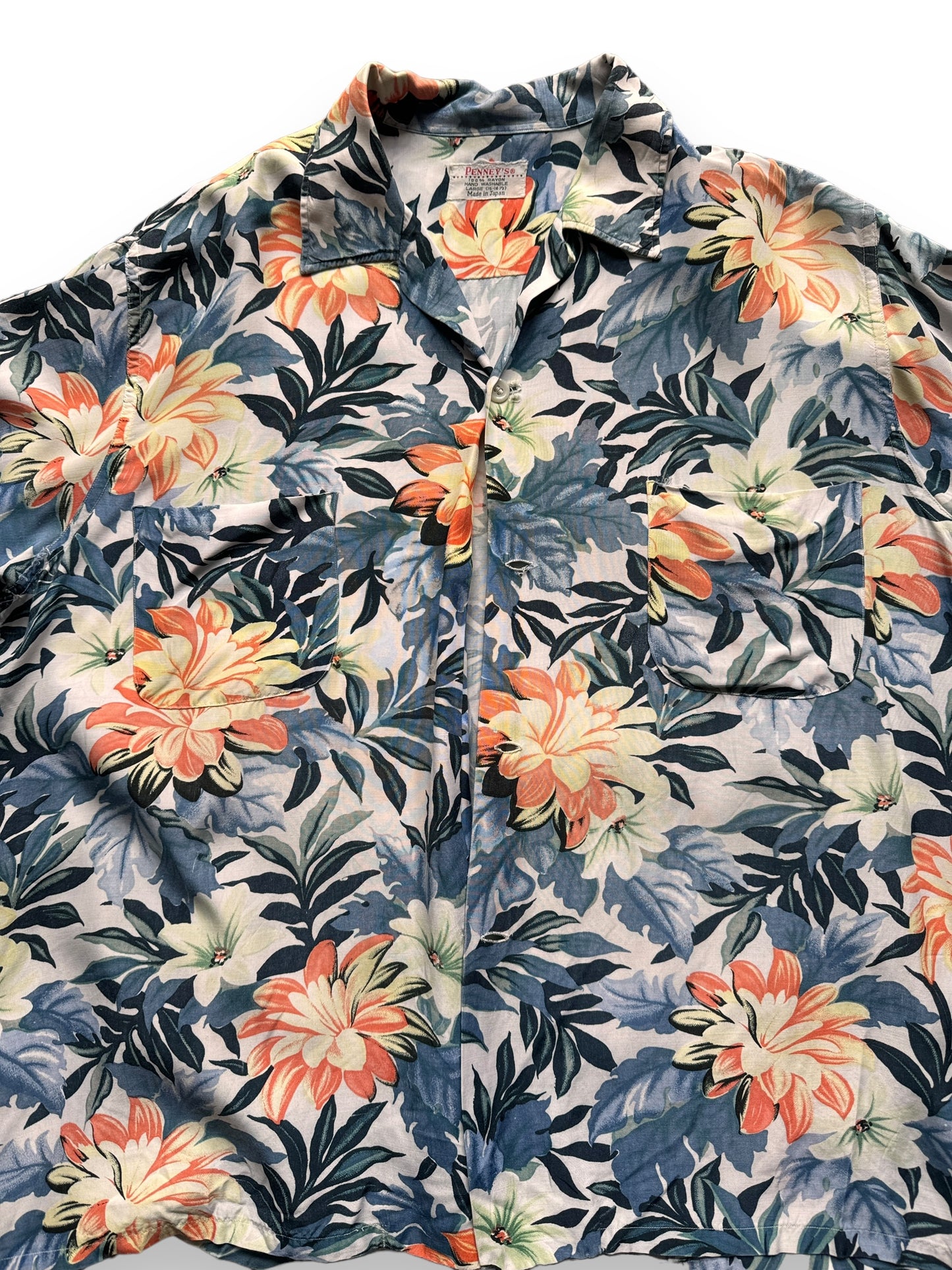 front close up of Vintage Made in Japan Navy Blue/Orange Floral Penney's Aloha Shirt SZ L