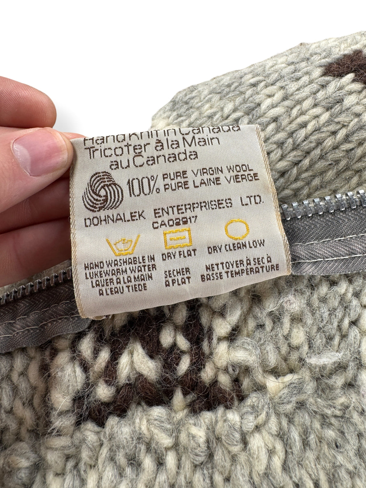 Back of care tag on Vintage Tauk Thunderbird Cowichan Style Sweater SZ S