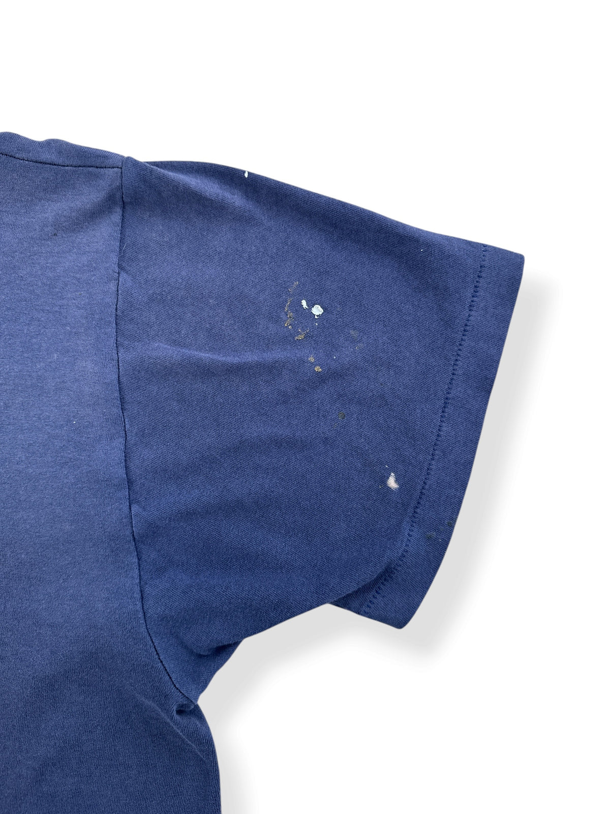 Paint on back sleeve of Vintage Distressed Navy Blue Pocket Tee SZ L