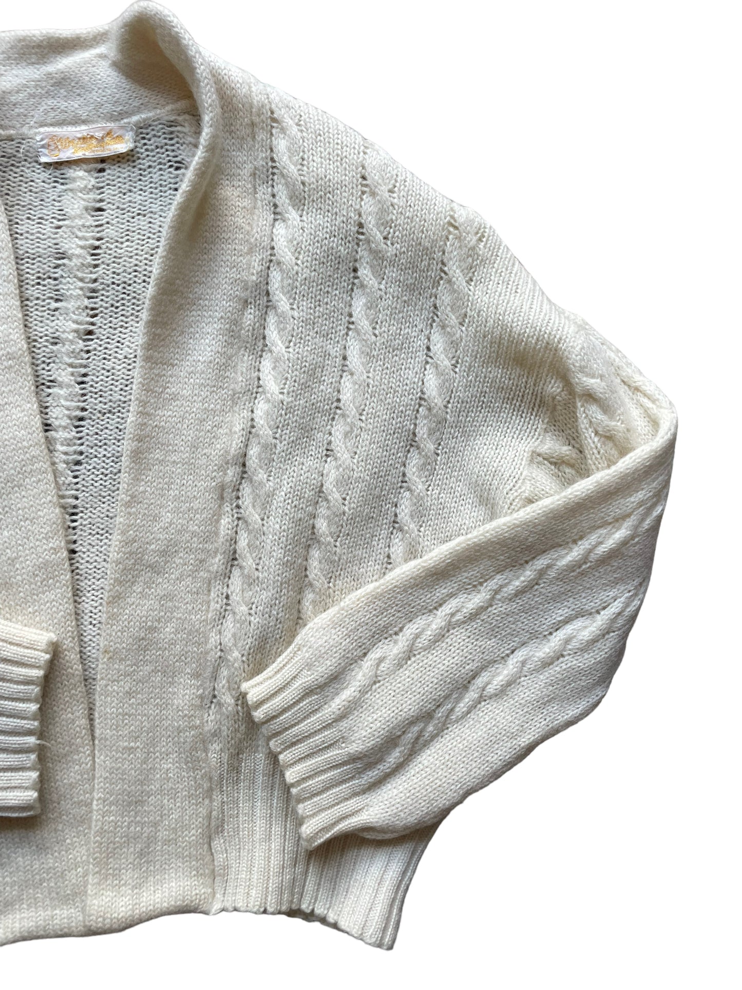 Front left side flat lay of Vintage 1950s Cable Knit Cardigan Sweater | Barn Owl Seattle | Seattle True Vintage