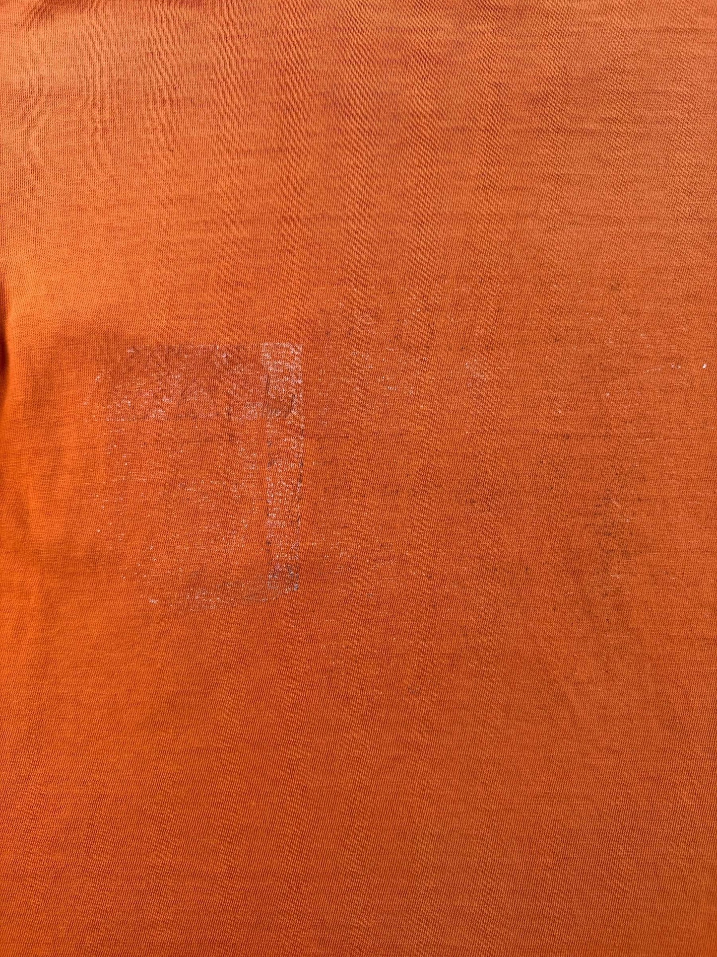 Faded graphic on back of Vintage 1960s Orange Cotton Pocket Tee SZ M