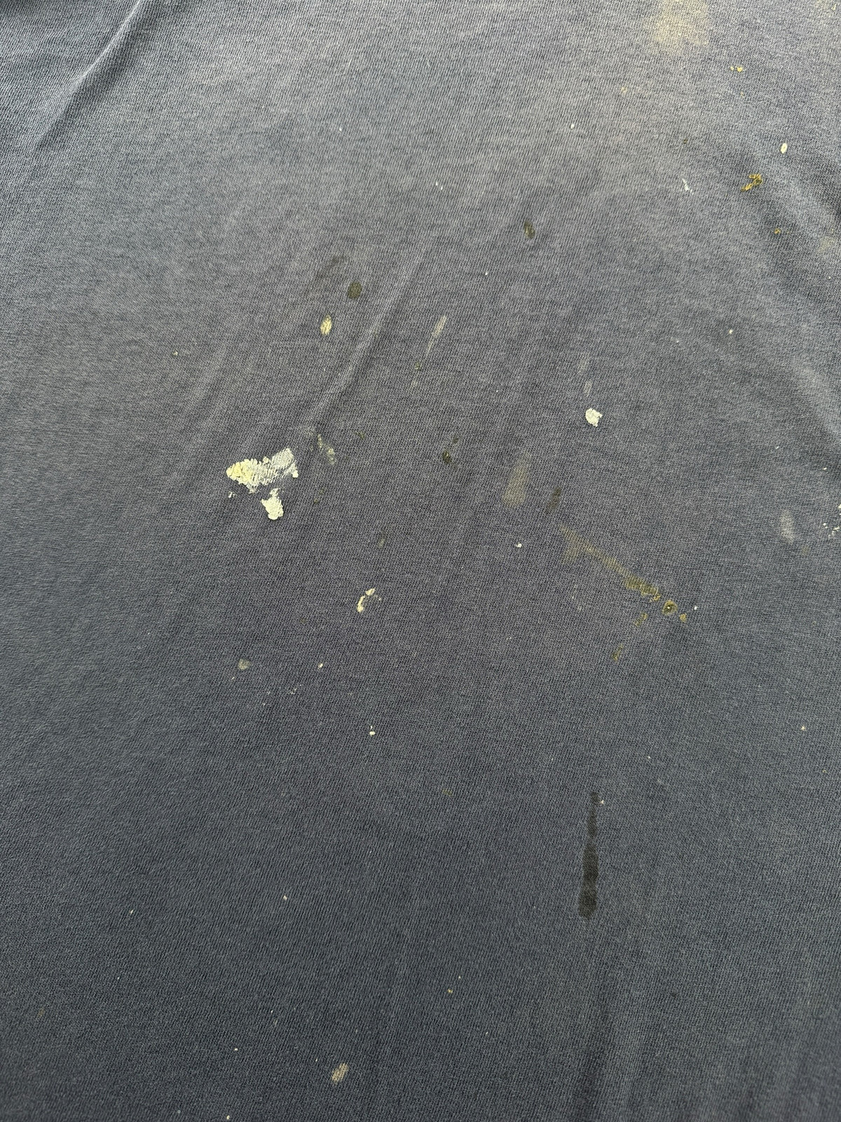 Paint on front of Vintage Distressed Navy Blue Pocket Tee SZ L