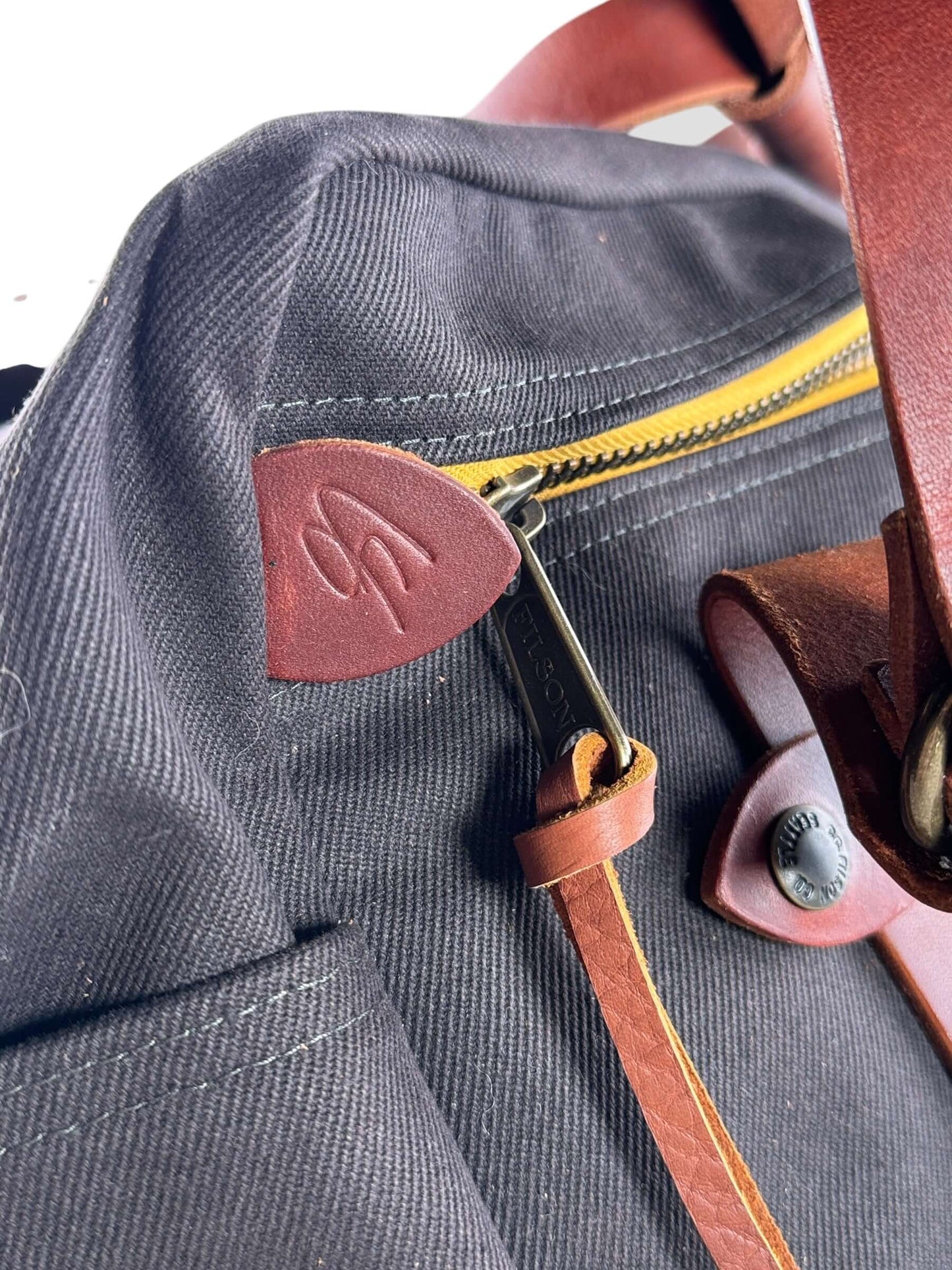 CS Embossed leather pull tab on Filson x Chris Stapleton Traveller Outfitter Bag NWOT