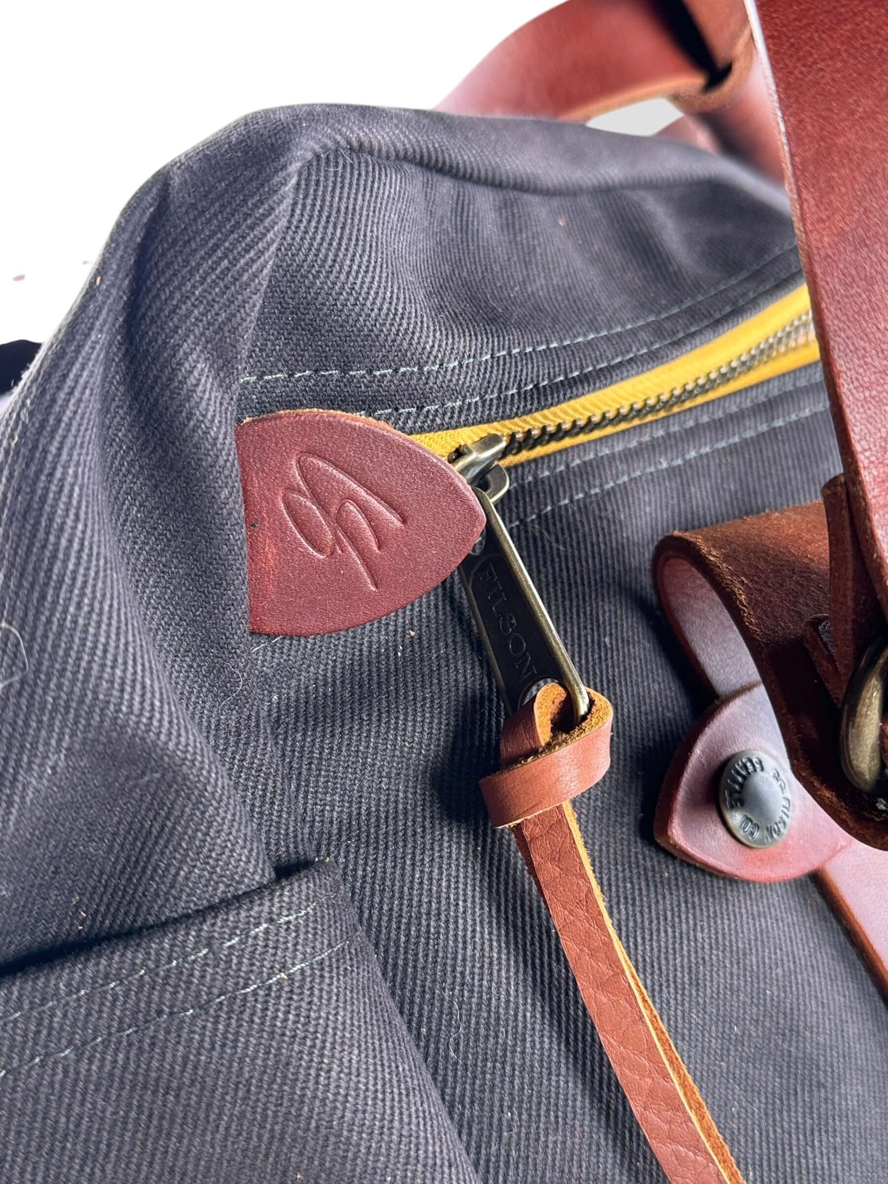 CS Embossed leather pull tab on Filson x Chris Stapleton Traveller Outfitter Bag NWOT