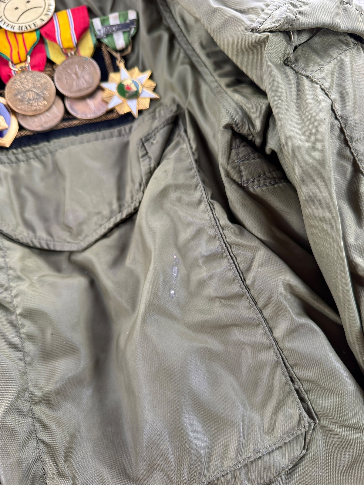 Wear on front pocket of Vintage Vietnam Winter Flyers Jacket w/ Patches SZ 46