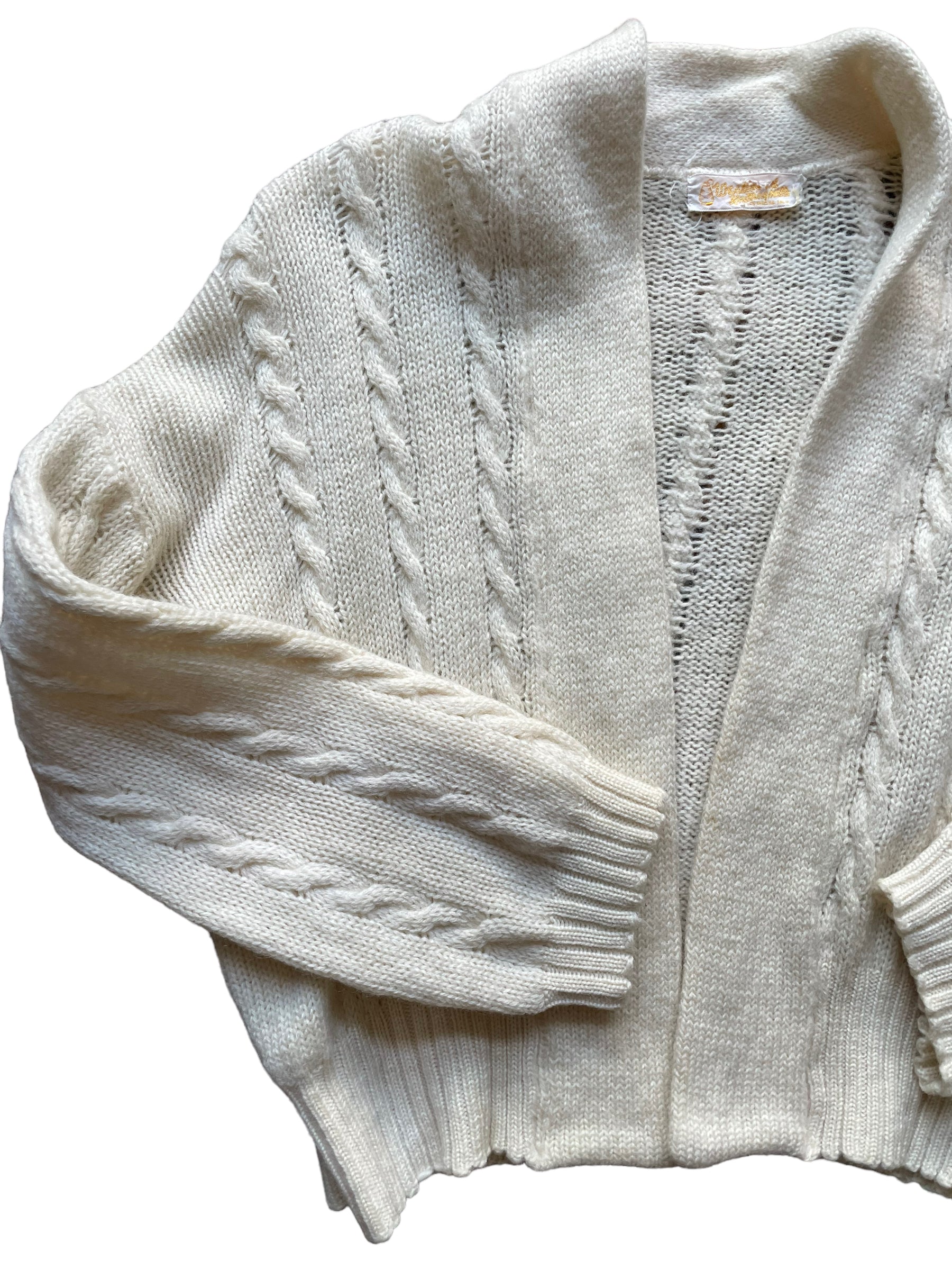 Front right side flat lay of Vintage 1950s Cable Knit Cardigan Sweater | Barn Owl Seattle | Seattle True Vintage