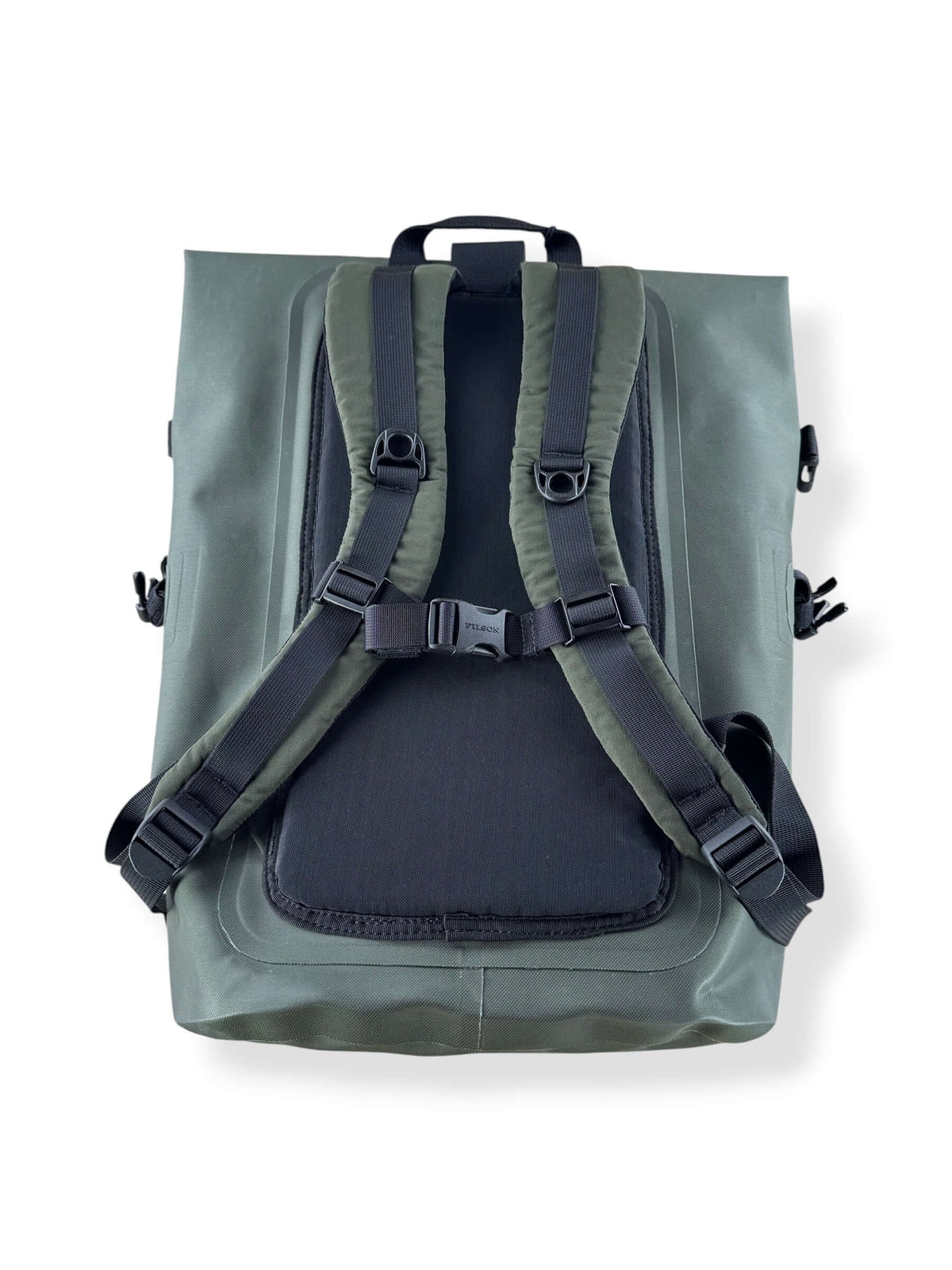 Layed down back of Filson NWT Green Dry Backpack