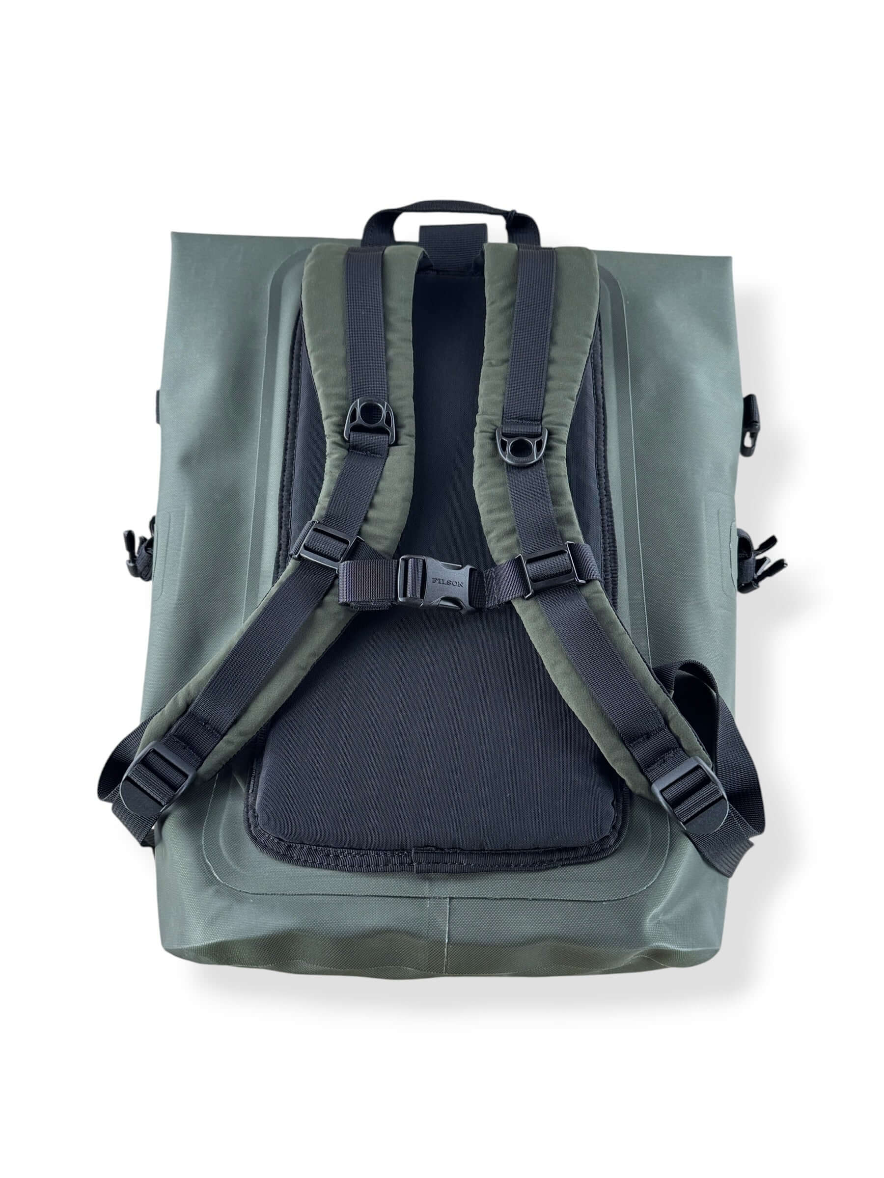 Layed down back of Filson NWT Green Dry Backpack