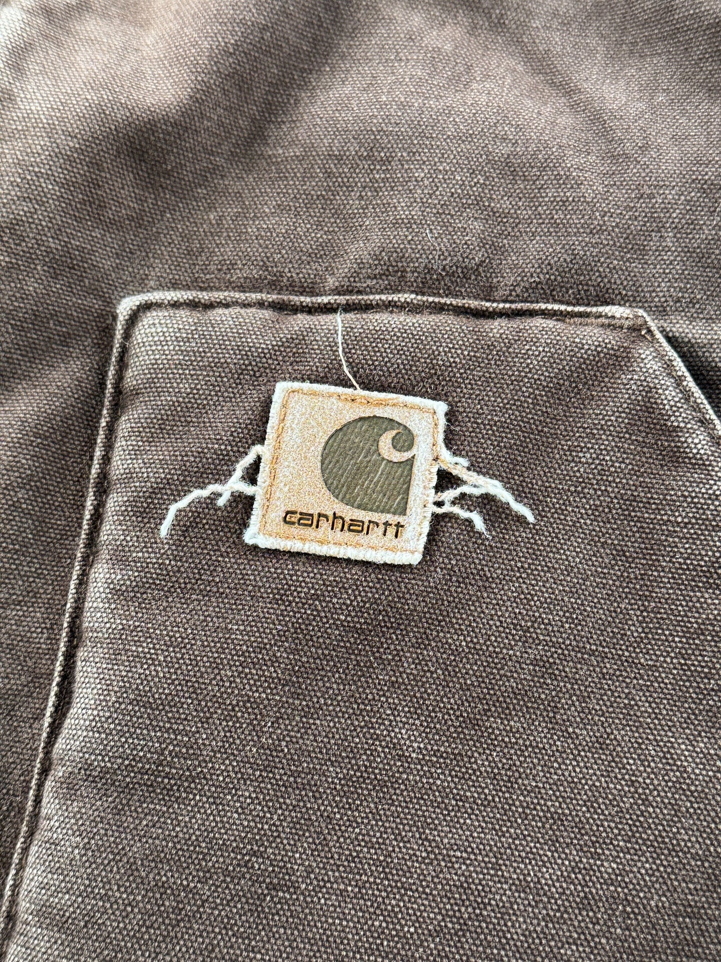 Label on pocket of Carhartt Brown Vest SZ L
