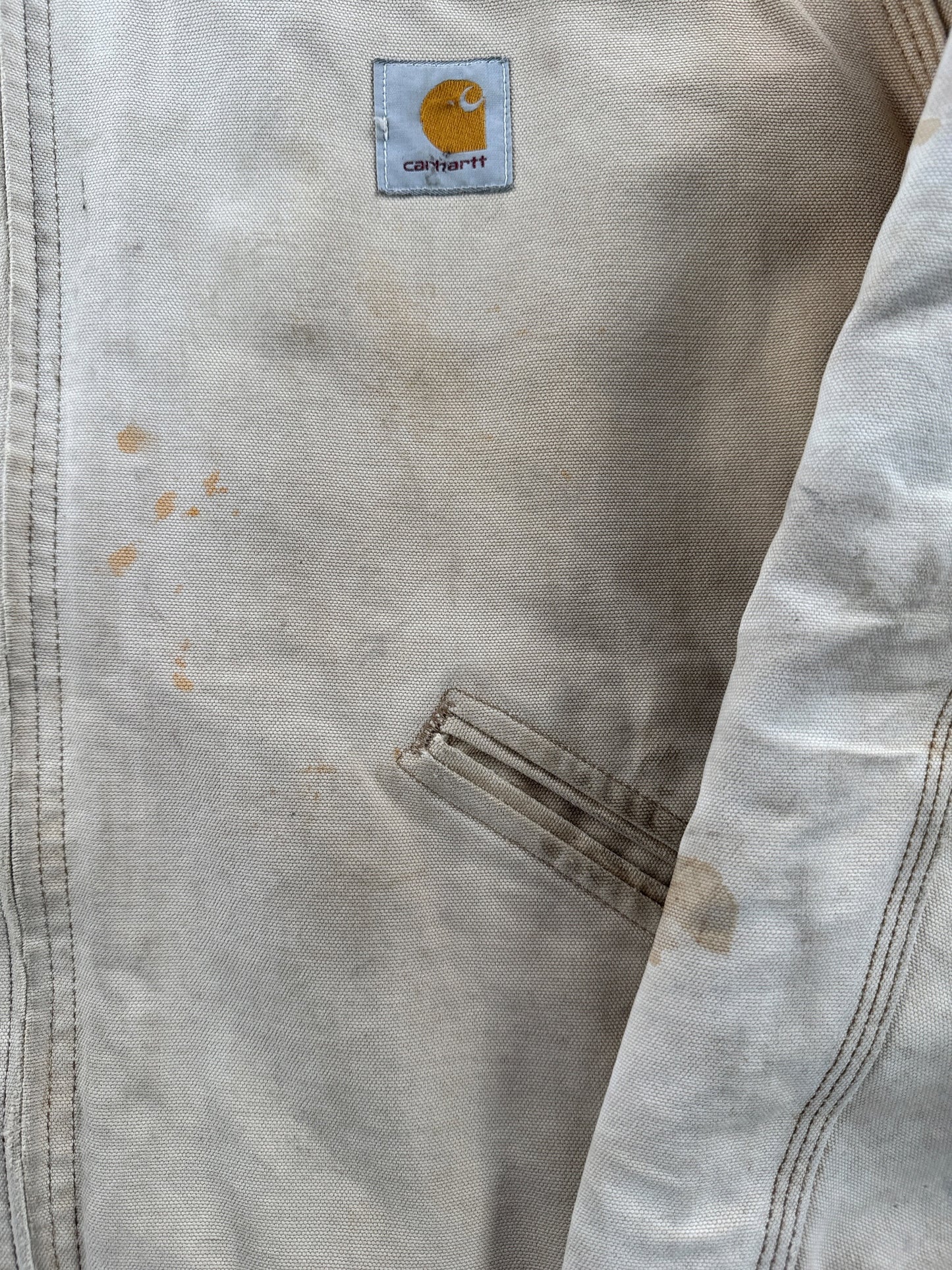Ware on front of Vintage 90’s Carhartt Faded Tan Detroit Jacket SZ XL