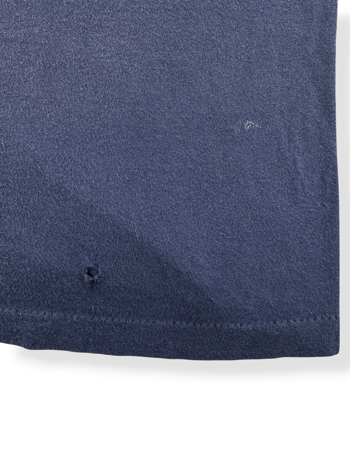 Hole near bottom hem on back of Vintage Navy Ghost Pocket Tee SZ M