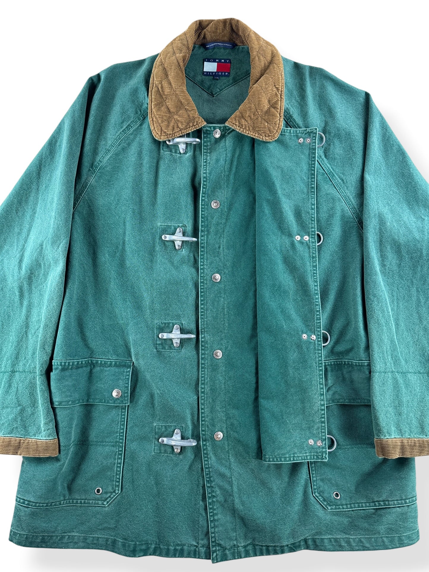 Button closure on Vintage Tommy Hilfiger Fireman Clasp Canvas Coat SZ L