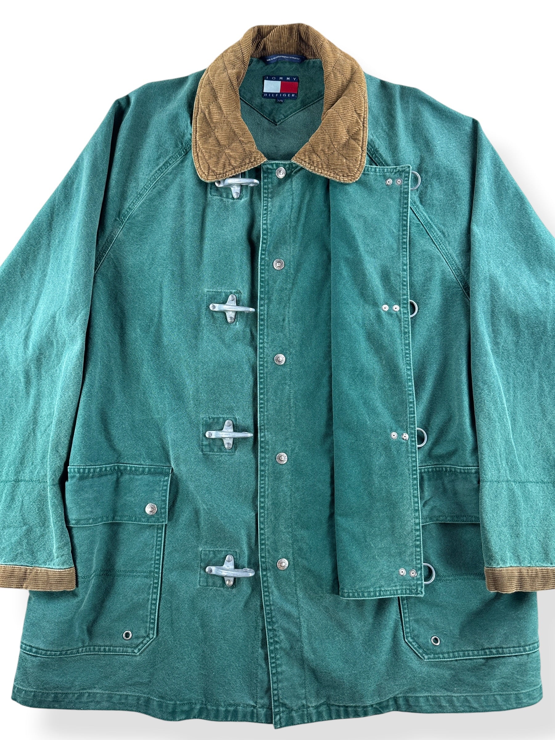 Button closure on Vintage Tommy Hilfiger Fireman Clasp Canvas Coat SZ L