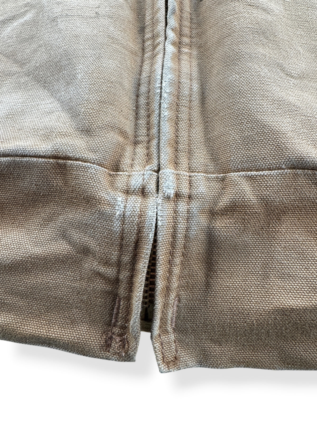 Wear near bottom of zipper on Carhartt Tan Hooded Jacket SZ L