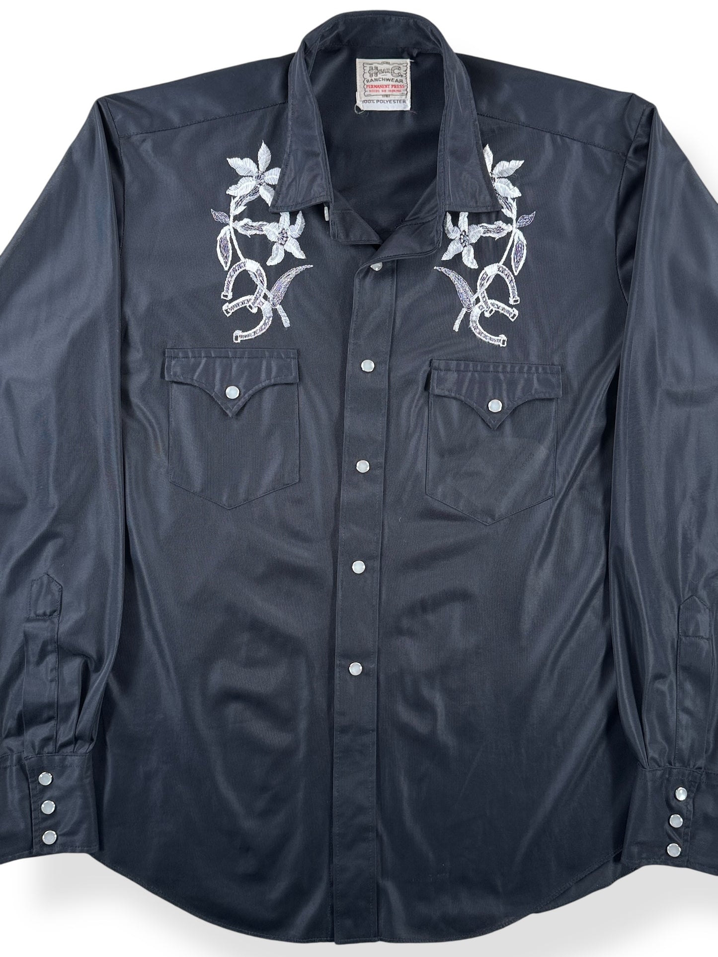 Front Close Up of Vintage H Bar C Black Polyester Flowers & Horseshoe Pearl Snap SZ L