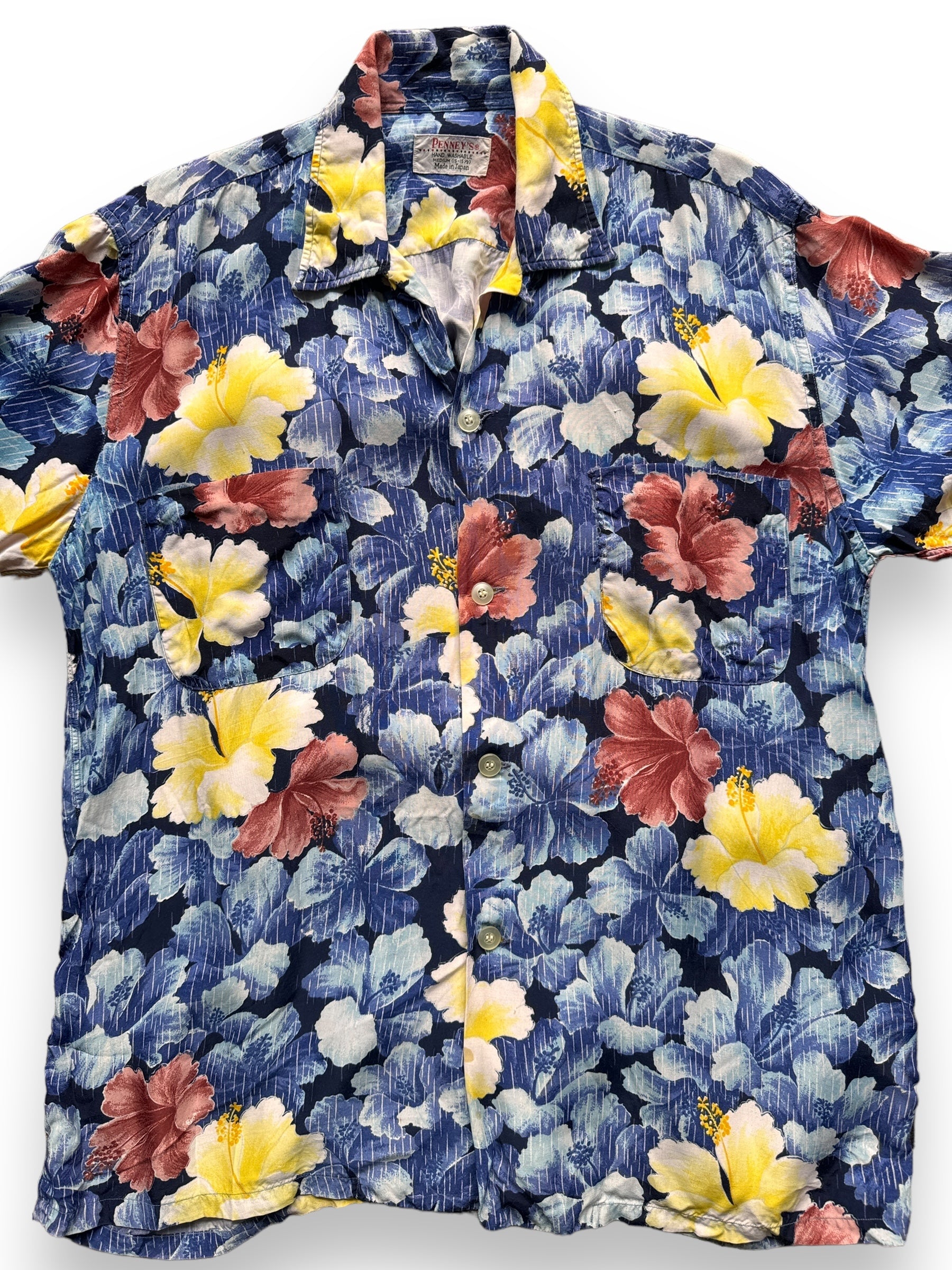 front close up of Vintage Made in Japan Blue/Yellow/Mauve Floral Penney's Aloha Shirt SZ M