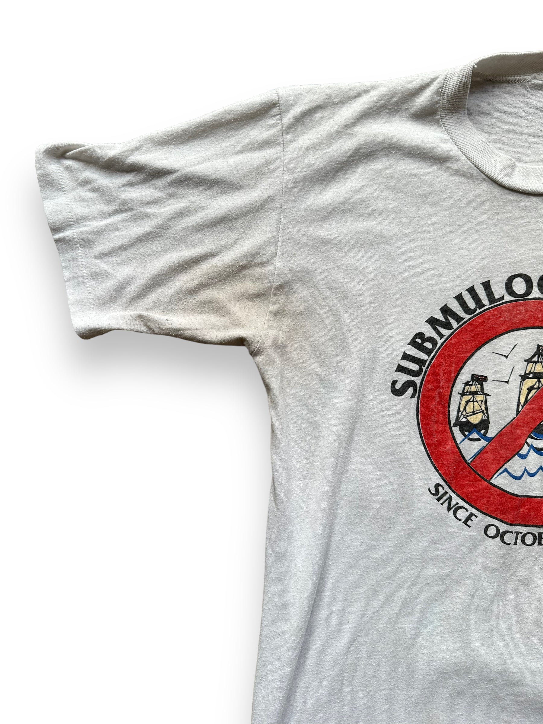 Slight Pitting on Right Pit of Vintage Submuloc First Nations Anti-Columbus Tee SZ M | Vintage Graphic T-Shirts Seattle | Barn Owl Vintage Tees Seattle