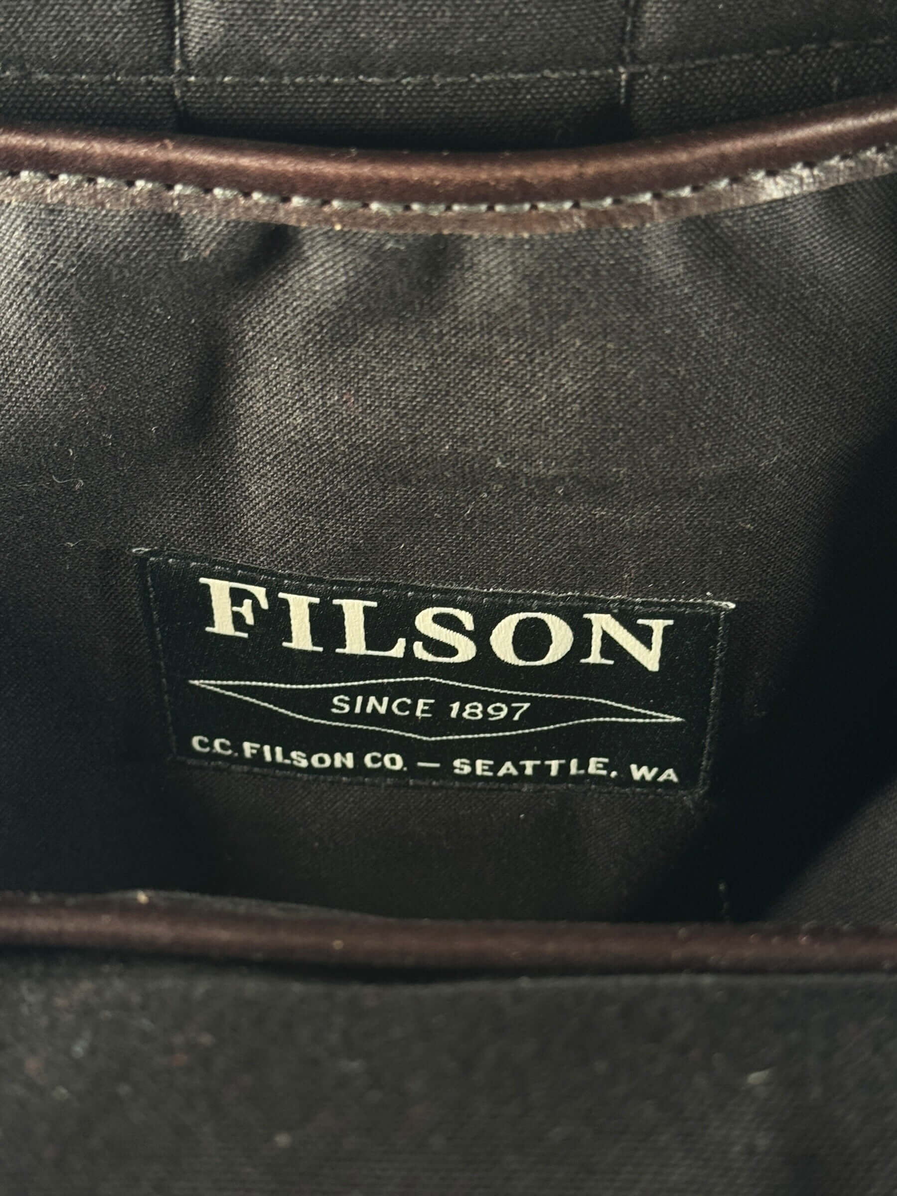 Filson tag on inside of Filson Weatherproof Sierra Brown Leather Journeyman Backpack