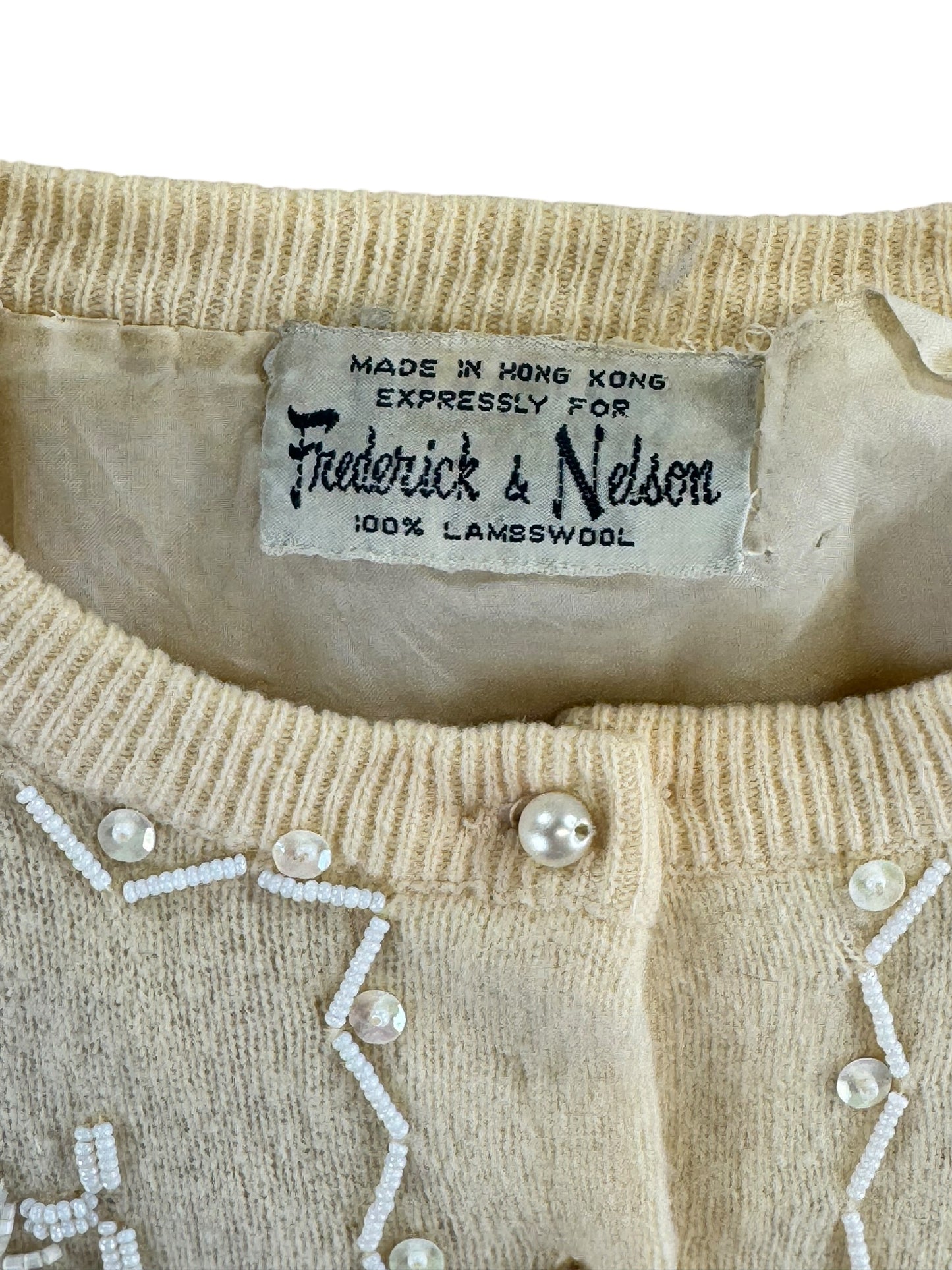 Tag view of 1950s Frederick and Nelson Beaded Lambswool Cardigan XL