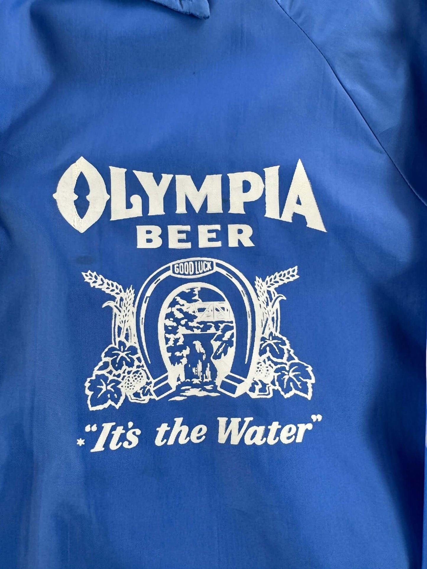 Graphic of Vintage Collegiate Pacific Olympia Beer Windbreaker SZ M