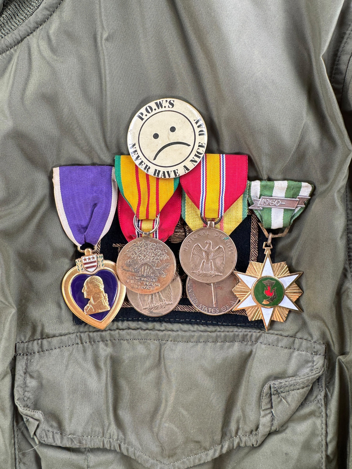 Pins and medals on front of Vintage Vietnam Winter Flyers Jacket w/ Patches SZ 46